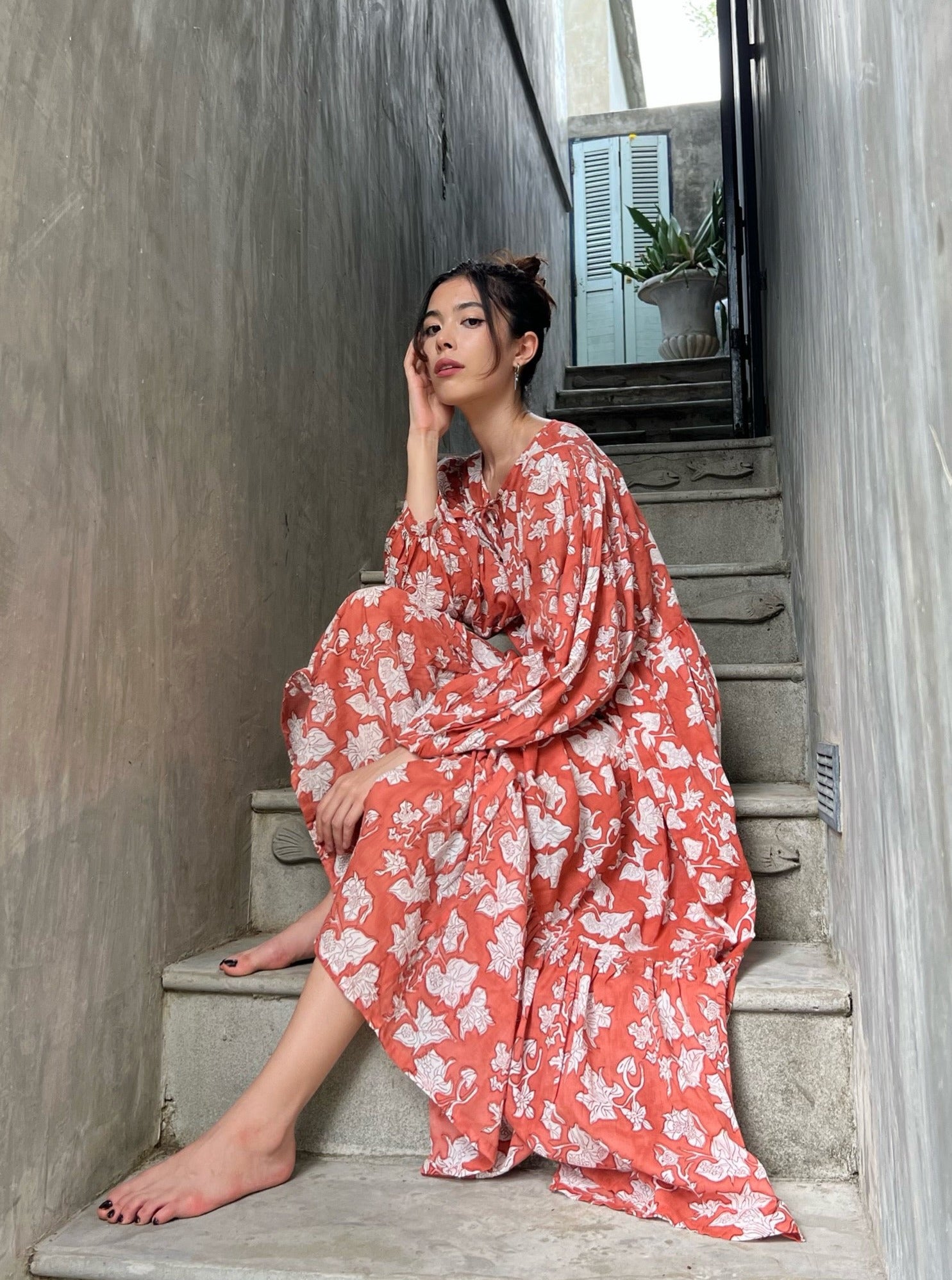 Shop Coco de Chom - new Introducing our Lola Bohemian Maxi Dress in Rust Limited Edition - an exceptionally unique piece available in limited quantities. The Lola's captivating design is handcrafted using wooden blocks meticulously placed on the finest cotton voile, resulting in a dreamy block printed pattern that draws inspiration from the bougainvillea flower and the vacation vibe. Wear it as a maxi dress for beach Boho vibes, style it as a bohemian outfit for festivals, or use it as a chic beach dress.