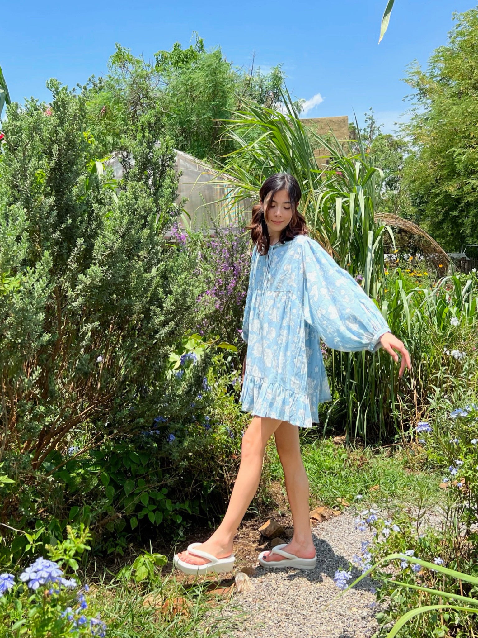Shop Coco de Chom Lola Bohemian Mini Dress in Beautiful Blue Sky - A Truly Unique Limited Edition Piece. Handcrafted with Wooden Blocks on Fine Cotton Voile, Showcasing a Dreamy Block Printed Pattern Inspired by Bougainvillea Flowers and Vacations. Ideal for Beach Days, Vacations, and Boho Enthusiasts.
