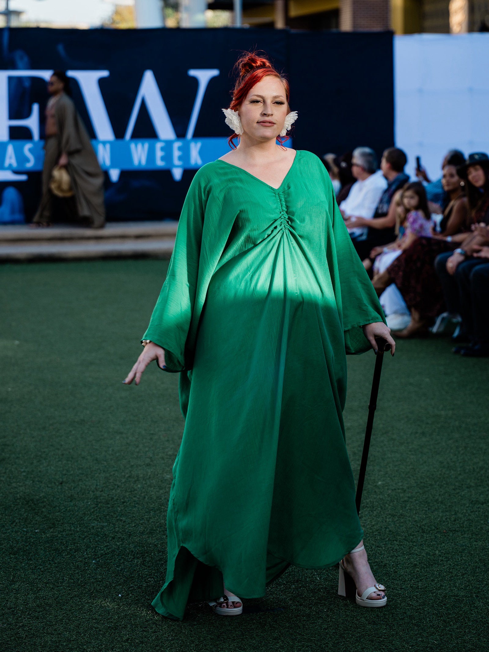 Woman in an Oversized emerald green long sleeve caftan maxi dress, plus size boho resort dress and cruise vacation outfit with airy flowy maxi movement