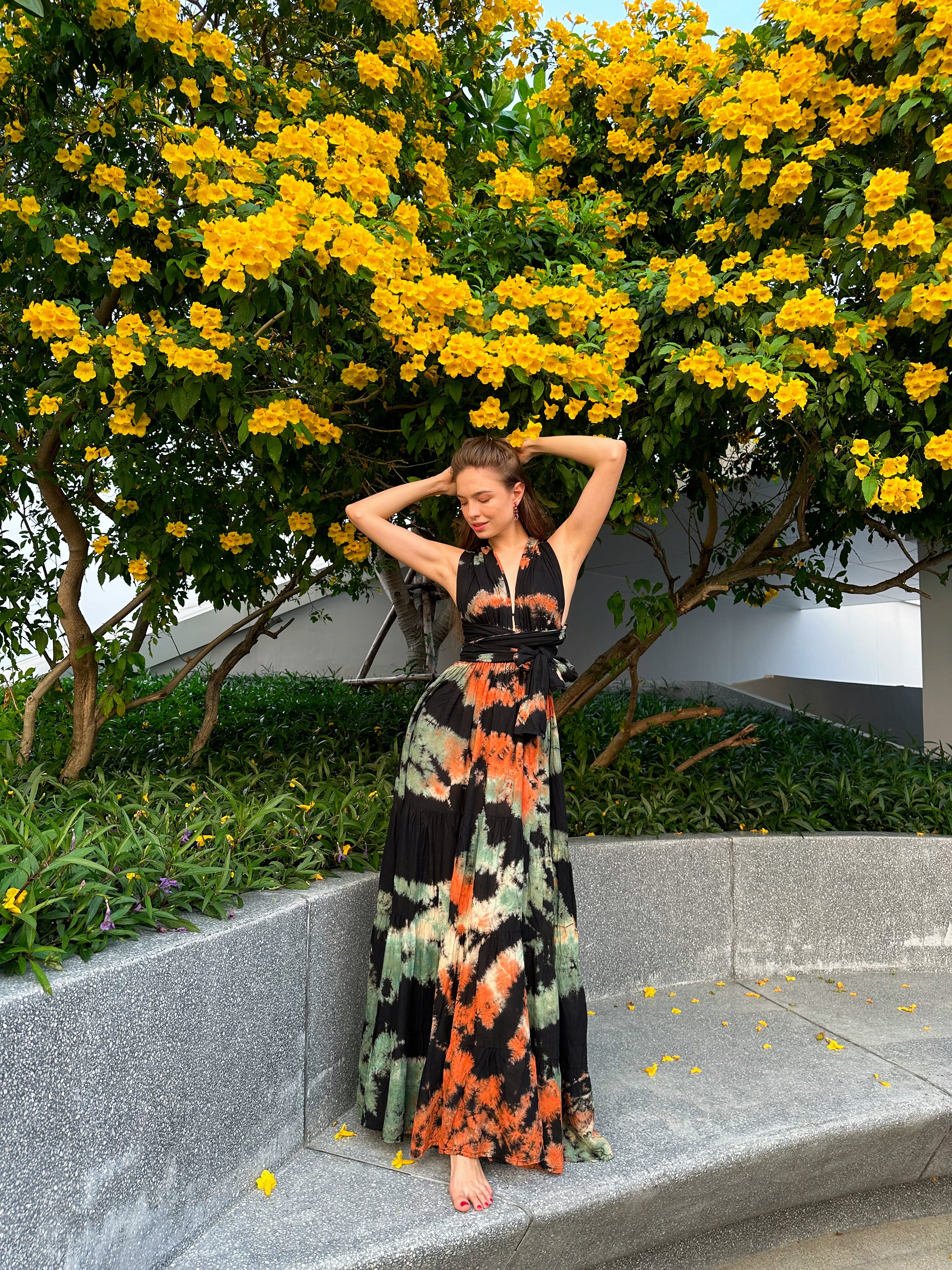 The Butterfly Infinity Maxi Dress Tie Dye is a limited edition piece featuring a maxi-length skirt and captivating hand-tie-dye pattern inspired by butterflies and vacation vibes. The dress is shown in a stylish and versatile design, suitable for transitioning seamlessly from day to night. With the Infinity Dress, you can explore different looks for any occasion. This lightweight and comfortable dress flatters all body types, making it perfect for bohemian style or resort wear.