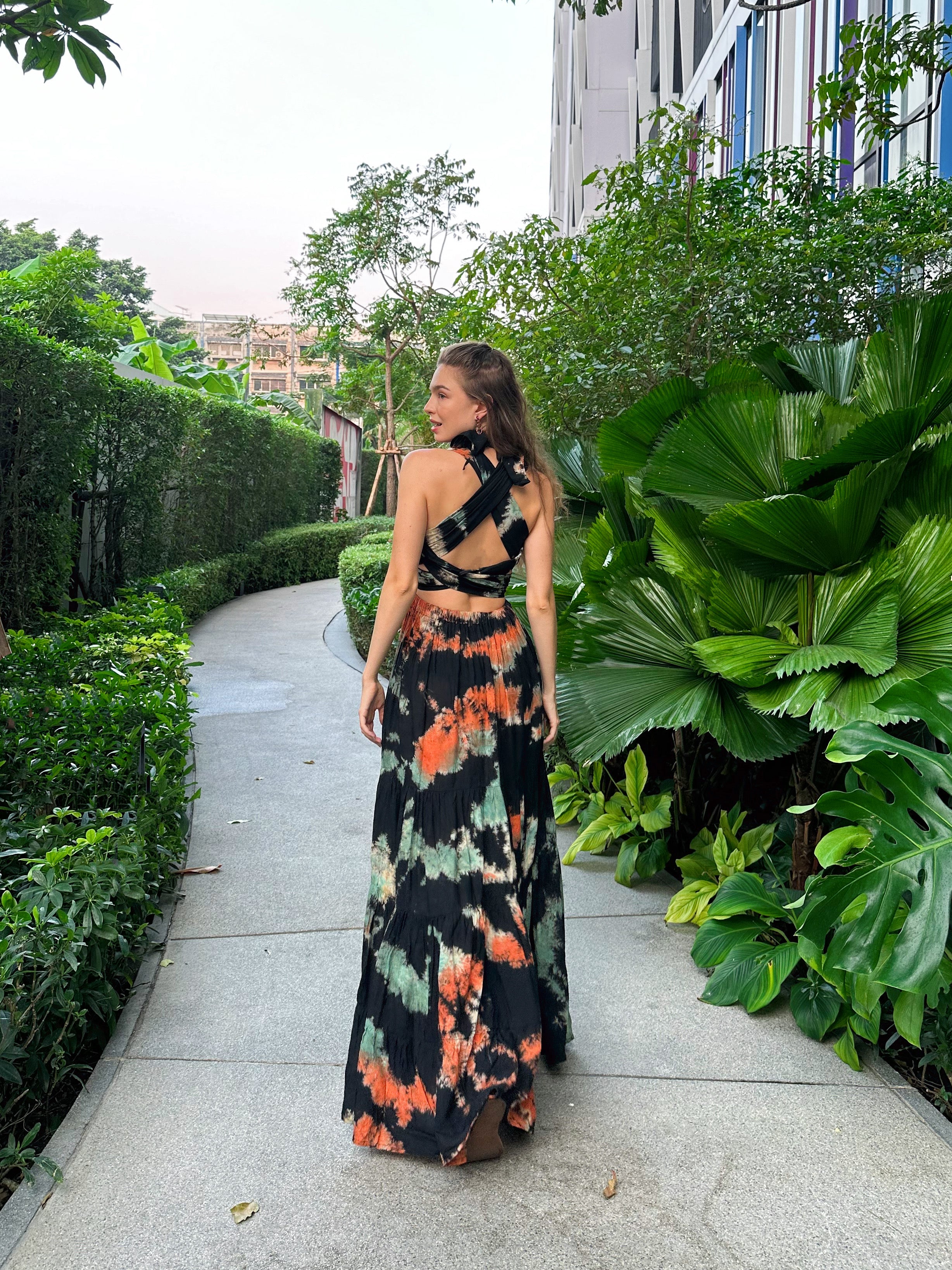 The Butterfly Infinity Maxi Dress Tie Dye is a limited edition piece featuring a maxi-length skirt and captivating hand-tie-dye pattern inspired by butterflies and vacation vibes. The dress is shown in a stylish and versatile design, suitable for transitioning seamlessly from day to night. With the Infinity Dress, you can explore different looks for any occasion. This lightweight and comfortable dress flatters all body types, making it perfect for bohemian style or resort wear.