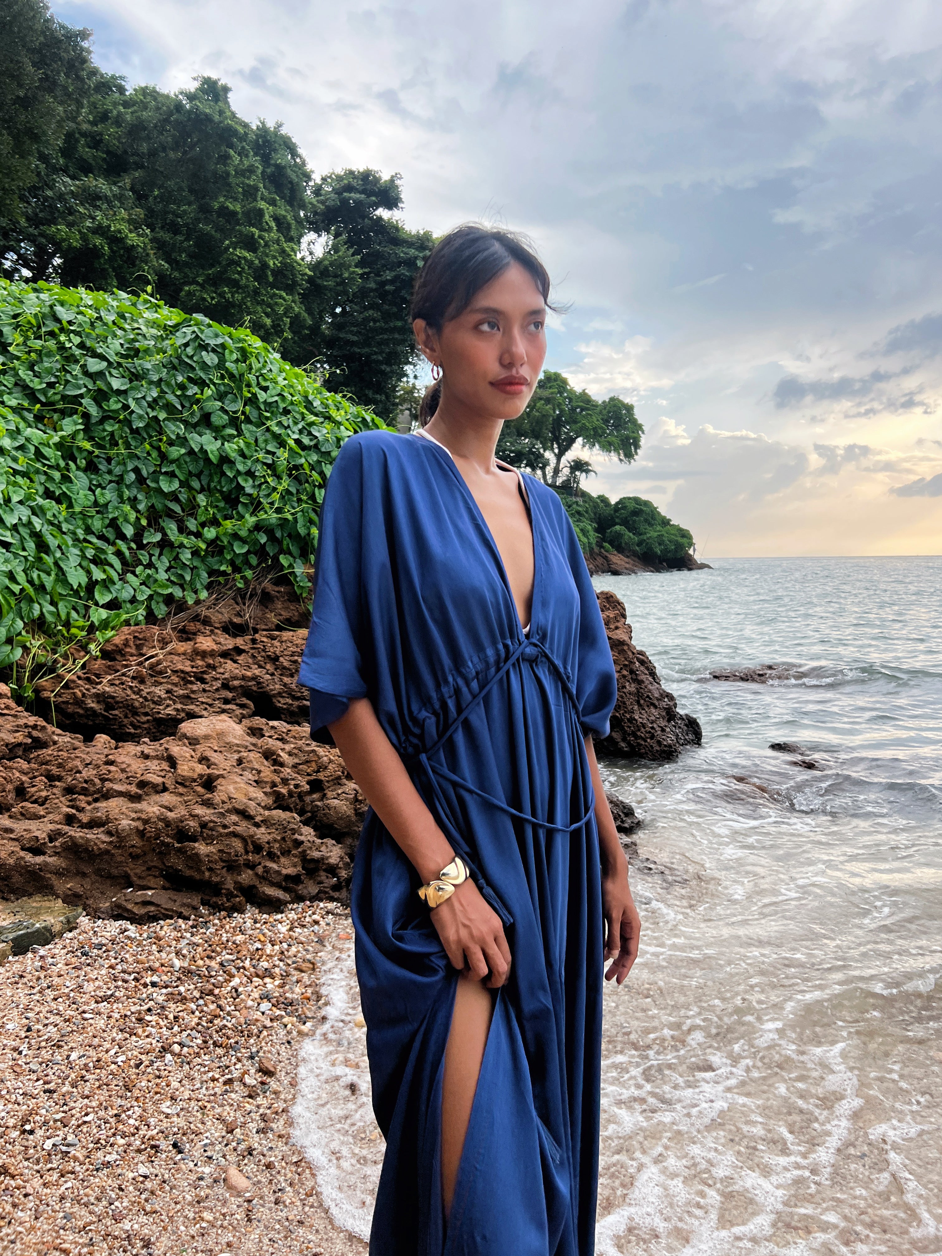 Shop comfort and elegance with our Goddess Kaftan Maxi Dress. This navy hand-dyed kaftan features a flowy, silky feel and a V-neck, making it the ideal choice for resort wear or vacation wear.