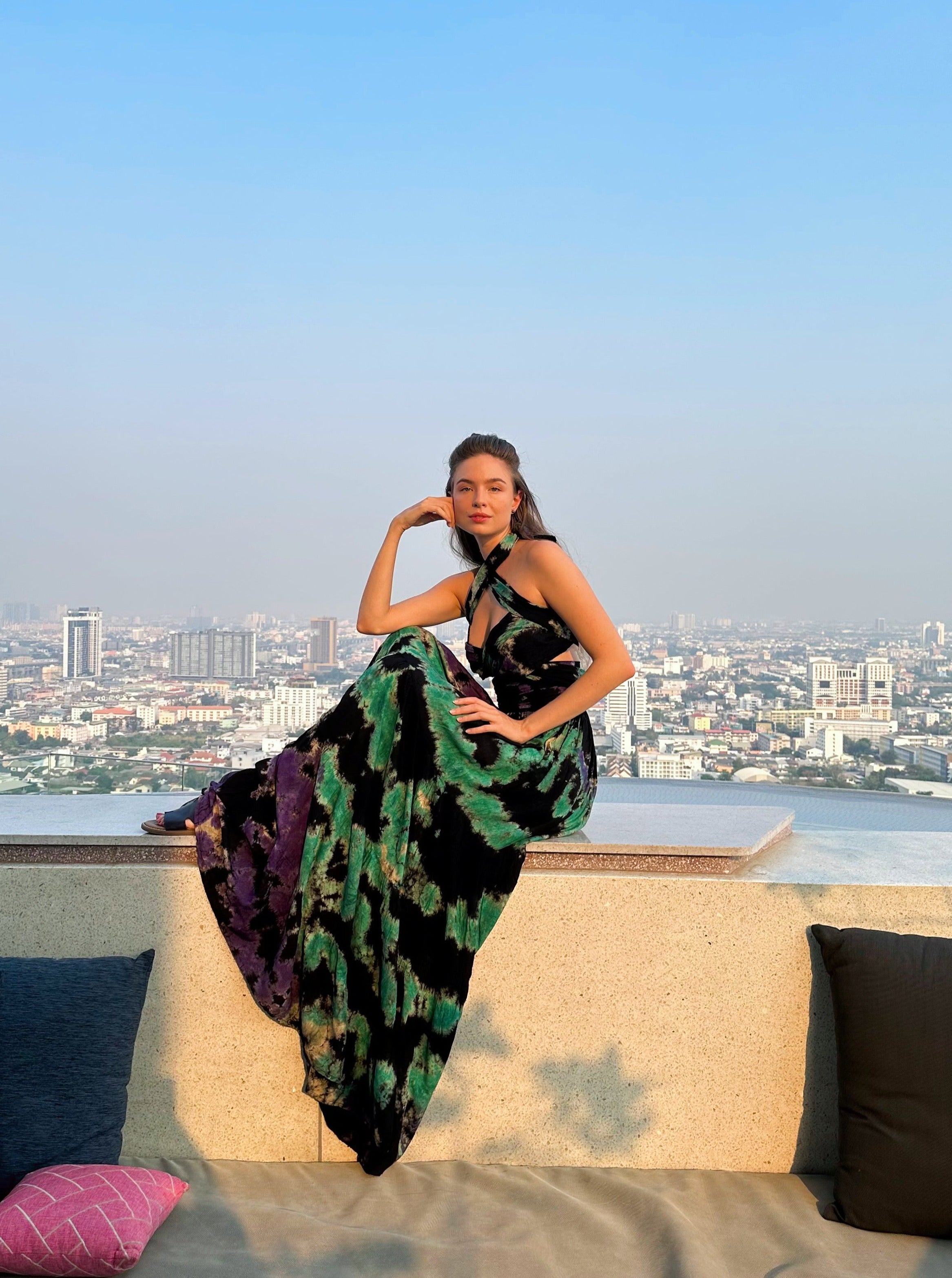 The Butterfly Infinity Maxi Dress Tie Dye is a limited edition piece featuring a maxi-length skirt and captivating hand-tie-dye pattern inspired by butterflies and vacation vibes. The dress is shown in a stylish and versatile design, suitable for transitioning seamlessly from day to night. With the Infinity Dress, you can explore different looks for any occasion. This lightweight and comfortable dress flatters all body types, making it perfect for bohemian style or resort wear.