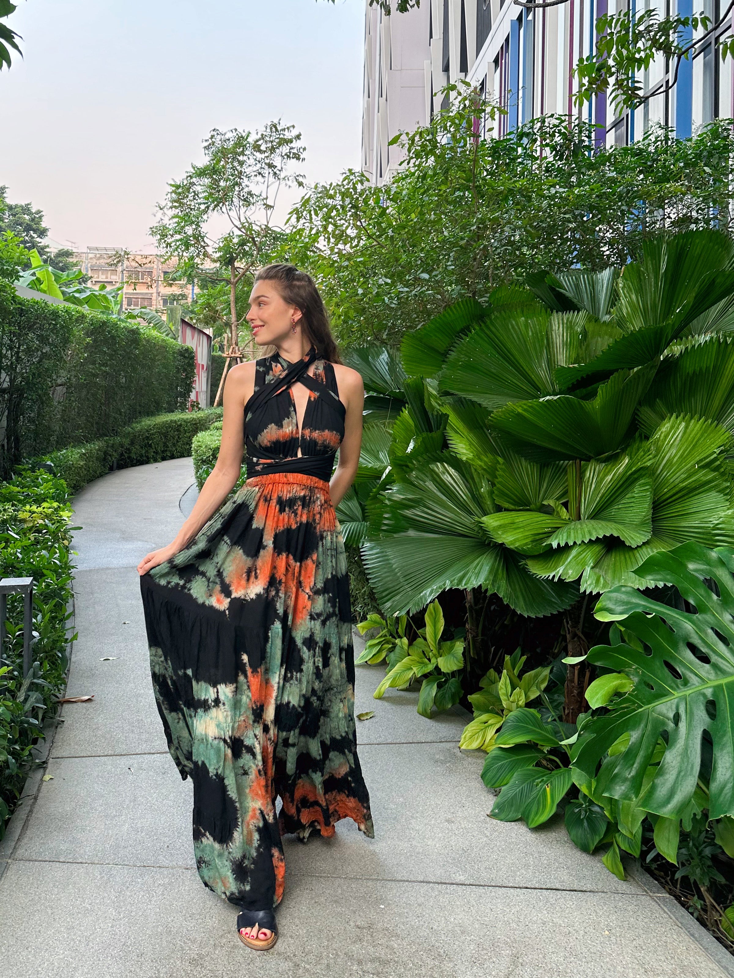 The Butterfly Infinity Maxi Dress Tie Dye is a limited edition piece featuring a maxi-length skirt and captivating hand-tie-dye pattern inspired by butterflies and vacation vibes. The dress is shown in a stylish and versatile design, suitable for transitioning seamlessly from day to night. With the Infinity Dress, you can explore different looks for any occasion. This lightweight and comfortable dress flatters all body types, making it perfect for bohemian style or resort wear.