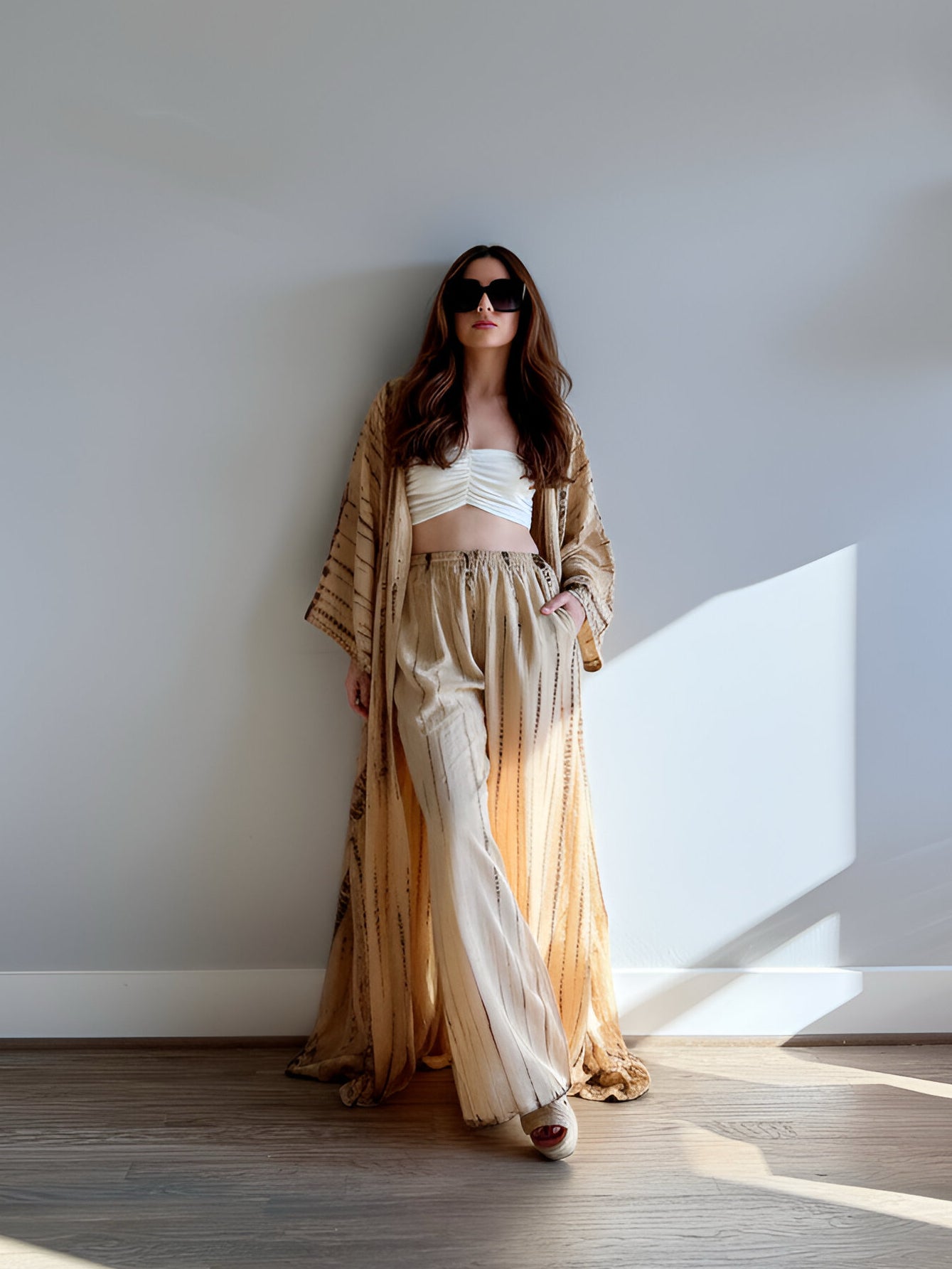 Woman wearing a tan tie-dye long kimono robe from Coco de Chom. The oversized robe features long sleeves, a waist tie, and a relaxed, boho-style fit.