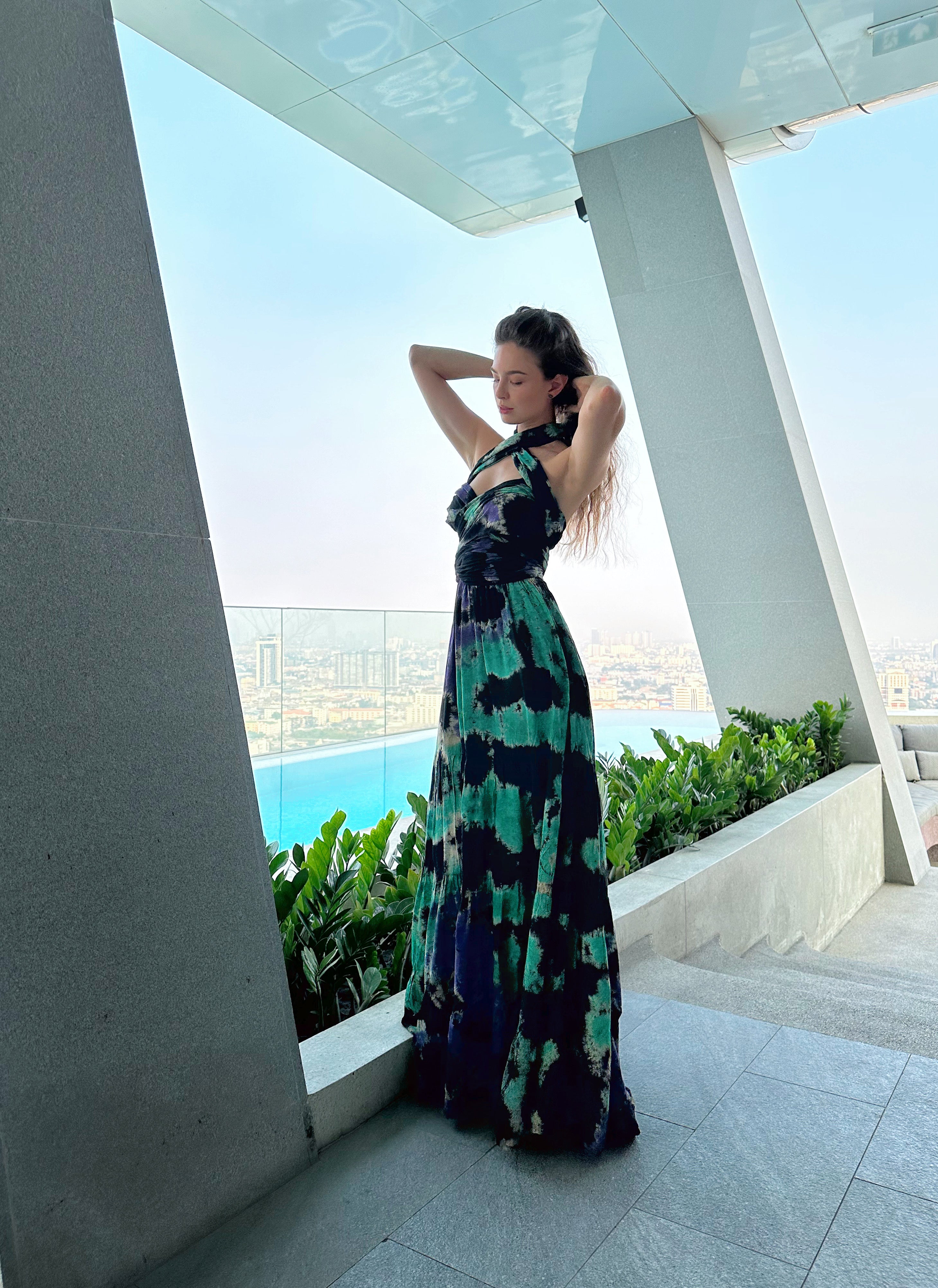 The Butterfly Infinity Maxi Dress Tie Dye is a limited edition piece featuring a maxi-length skirt and captivating hand-tie-dye pattern inspired by butterflies and vacation vibes. The dress is shown in a stylish and versatile design, suitable for transitioning seamlessly from day to night. With the Infinity Dress, you can explore different looks for any occasion. This lightweight and comfortable dress flatters all body types, making it perfect for bohemian style or resort wear.