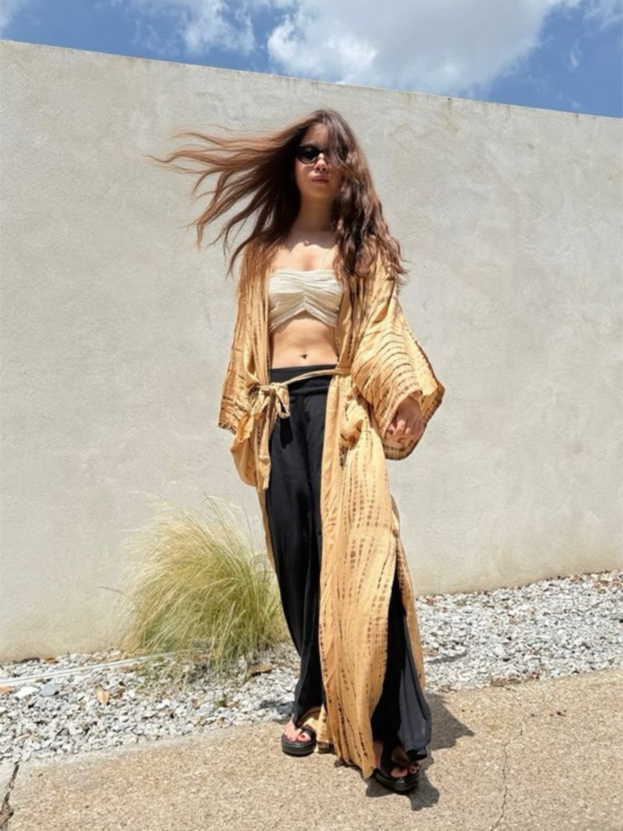 Woman wearing a tan tie-dye long kimono robe from Coco de Chom. The oversized robe features long sleeves, a waist tie, and a relaxed, boho-style fit.