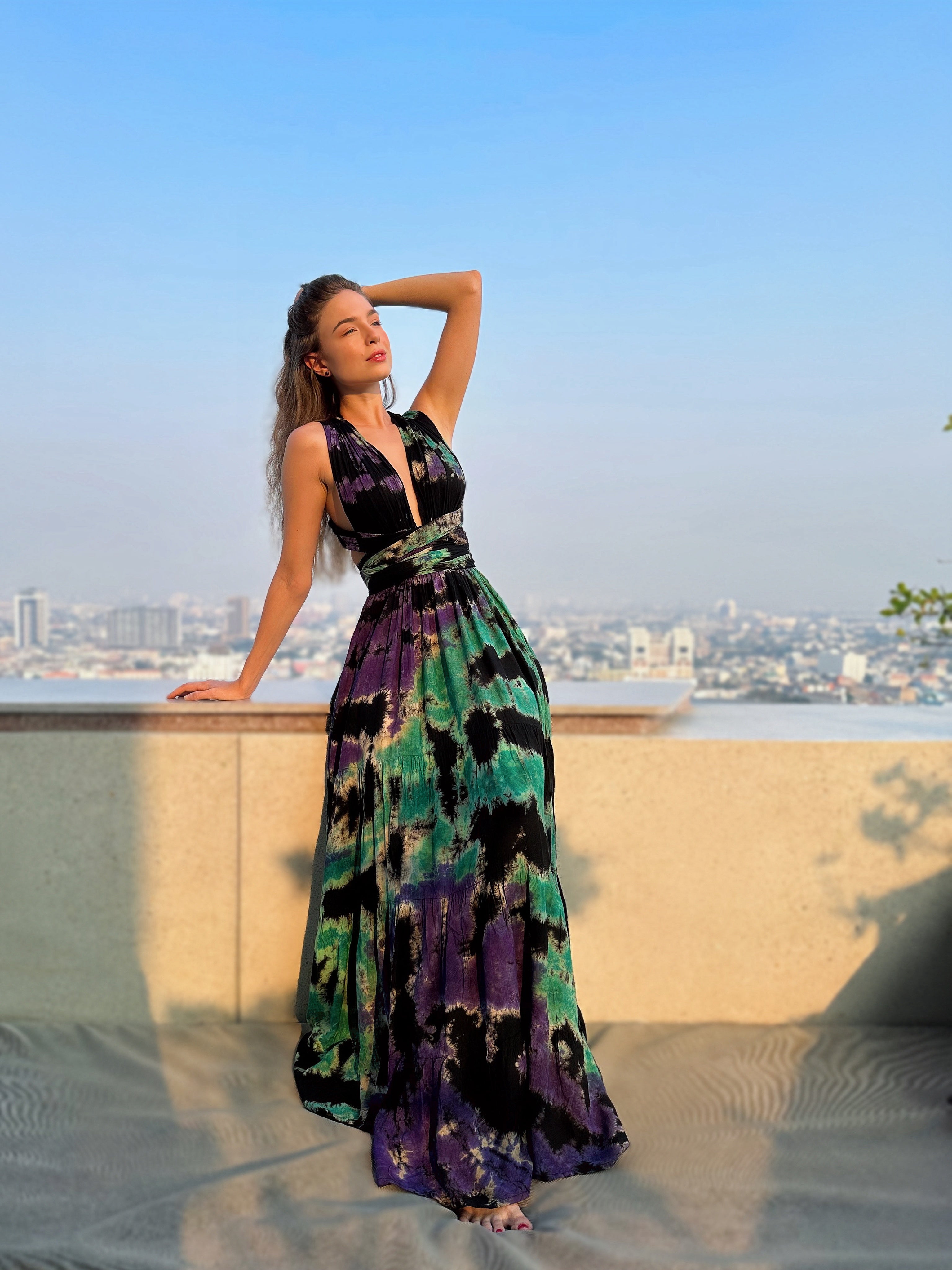 he Butterfly Infinity Maxi Dress Tie Dye is a limited edition piece featuring a maxi-length skirt and captivating hand-tie-dye pattern inspired by butterflies and vacation vibes. The dress is shown in a stylish and versatile design, suitable for transitioning seamlessly from day to night. With the Infinity Dress, you can explore different looks for any occasion. This lightweight and comfortable dress flatters all body types, making it perfect for bohemian style or resort wear.