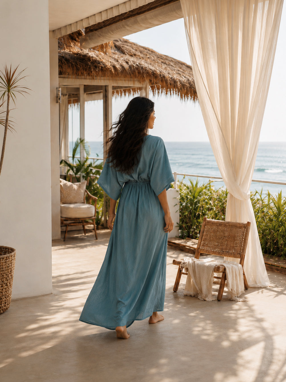 Teal kaftan dress styled as a long caftan dress for elevated resort wear, worn barefoot in a tropical oceanfront villa with breezy vacation style.