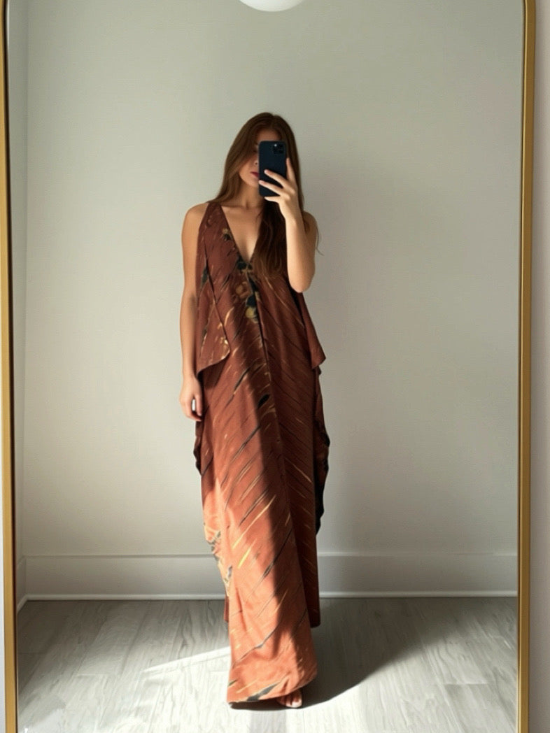 Woman taking a mirror selfie wearing a brown tie dye kaftan dress.
