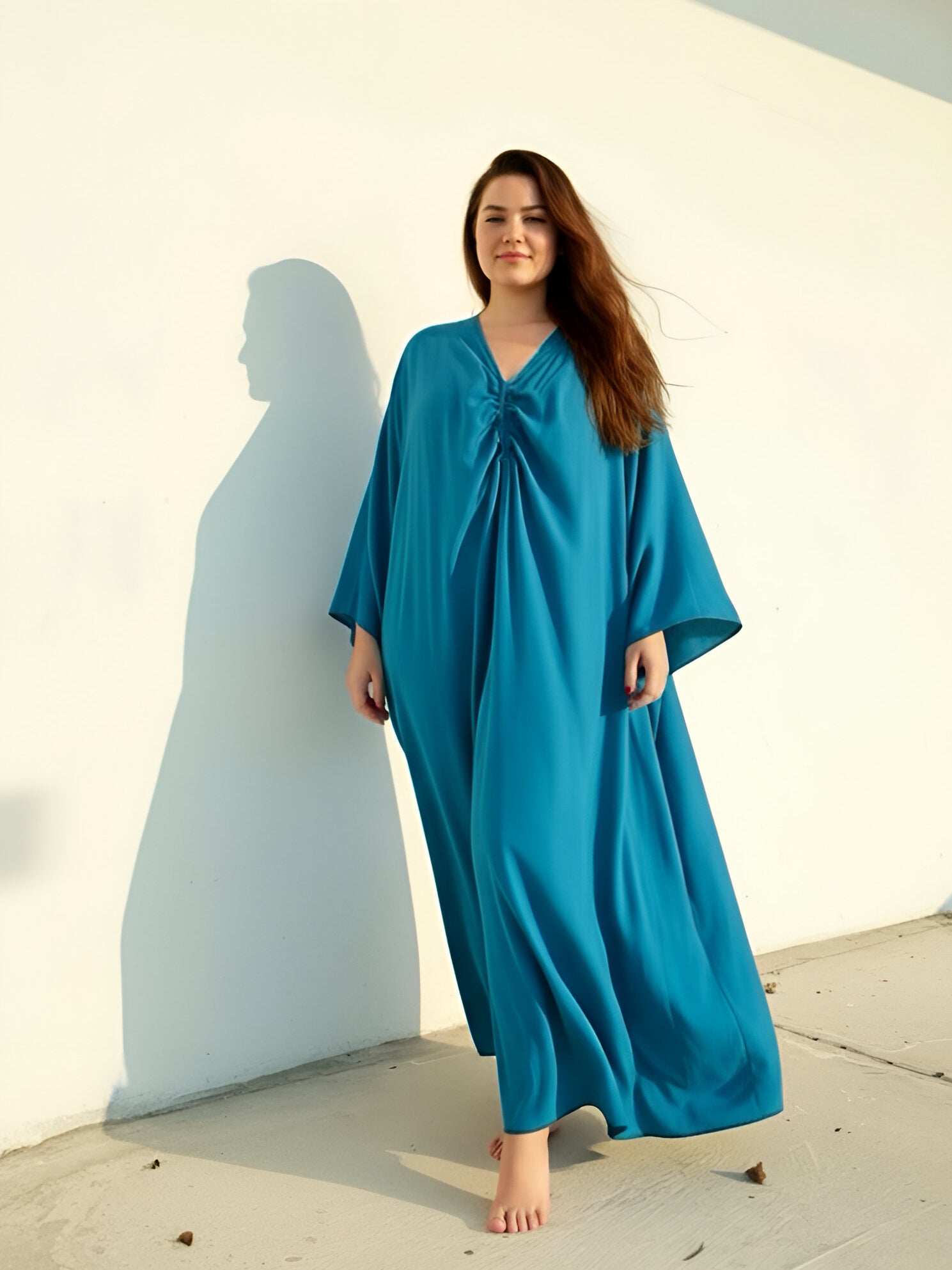 Woman plus size wearing teal blue kaftan maxi, plus size swim cover up and resort dress, relaxed oversized fit with airy movement