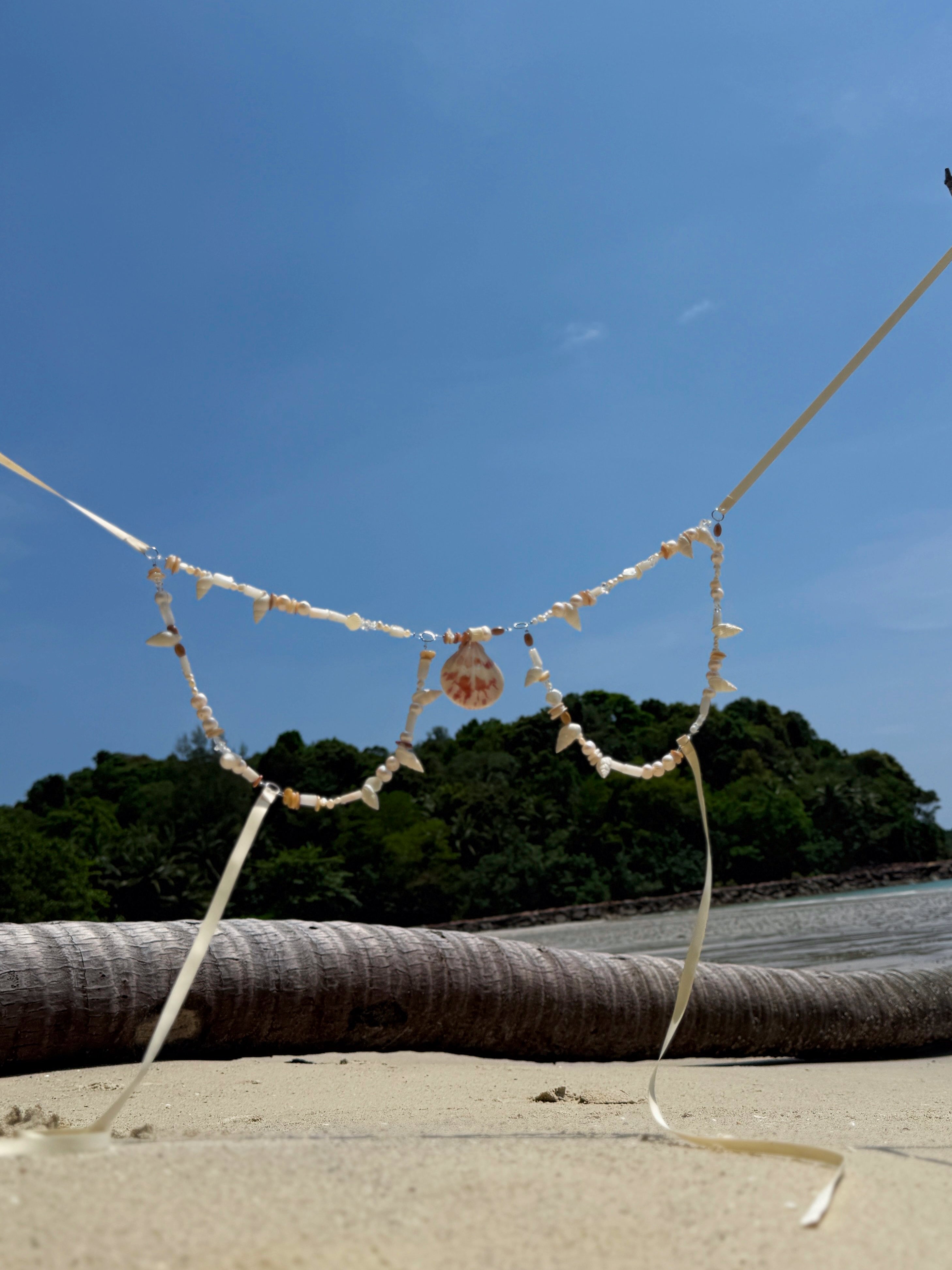 Handcrafted Boho Mermaid Pearl Bra made with real shells and pearl details, styled as a festival top or summer beachwear accessory—paired with a boho choker necklace by Coco de Chom.