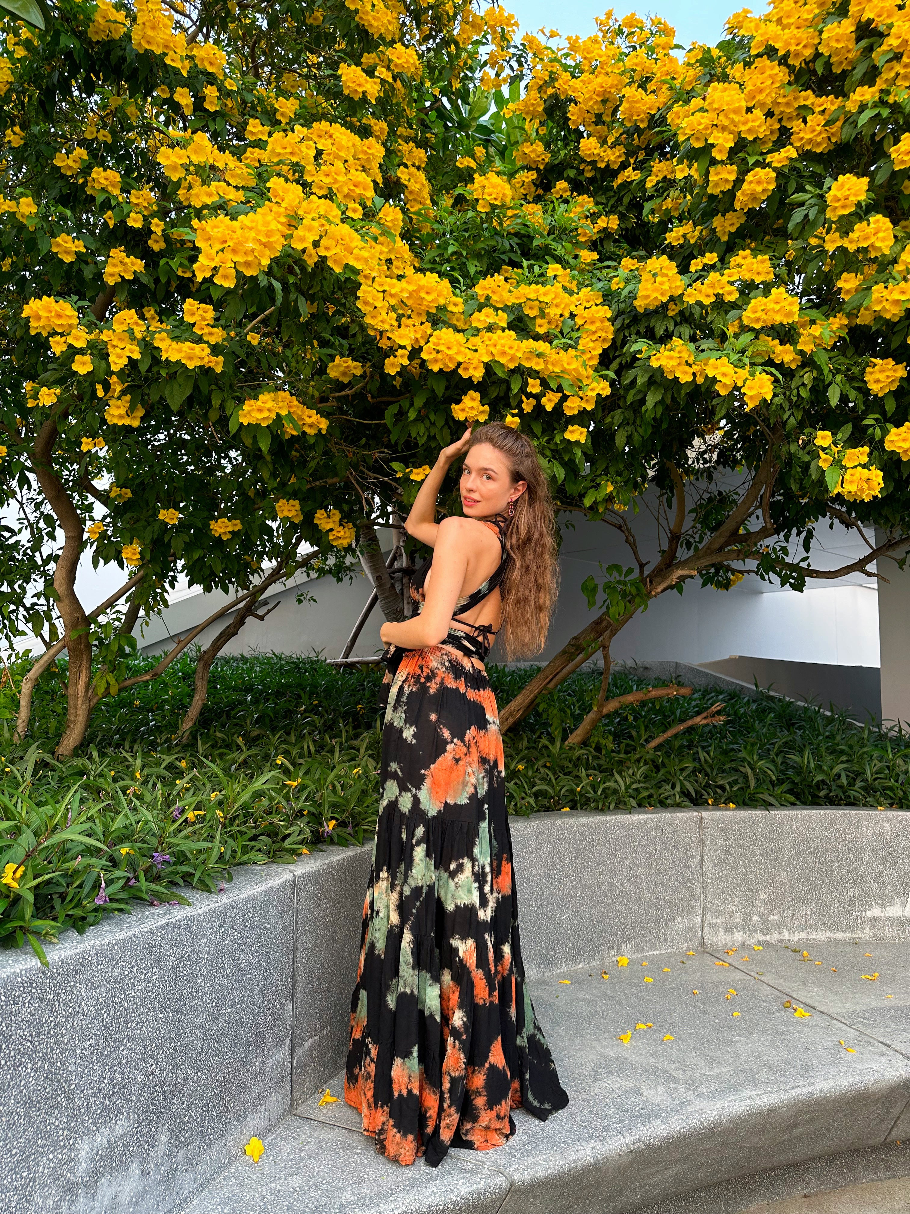 The Butterfly Infinity Maxi Dress Tie Dye is a limited edition piece featuring a maxi-length skirt and captivating hand-tie-dye pattern inspired by butterflies and vacation vibes. The dress is shown in a stylish and versatile design, suitable for transitioning seamlessly from day to night. With the Infinity Dress, you can explore different looks for any occasion. This lightweight and comfortable dress flatters all body types, making it perfect for bohemian style or resort wear.