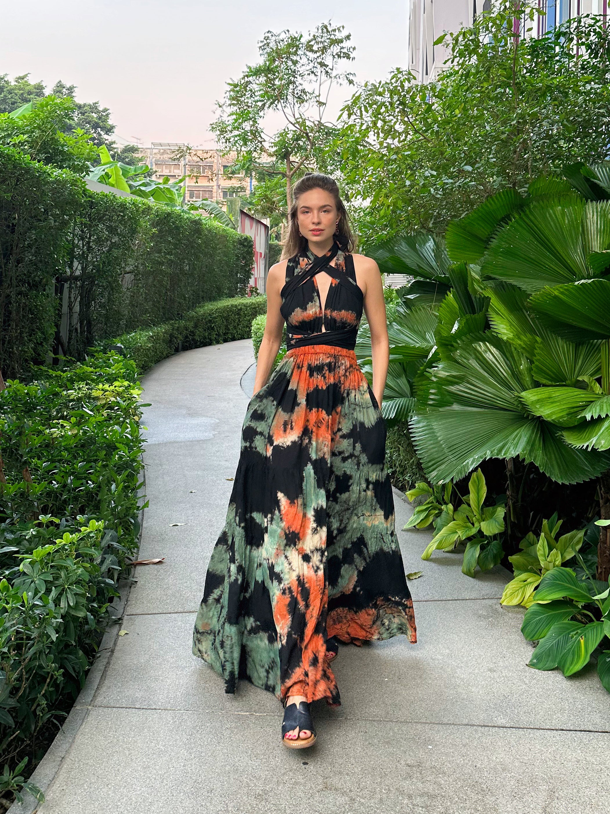 The Butterfly Infinity Maxi Dress Tie Dye is a limited edition piece featuring a maxi-length skirt and captivating hand-tie-dye pattern inspired by butterflies and vacation vibes. The dress is shown in a stylish and versatile design, suitable for transitioning seamlessly from day to night. With the Infinity Dress, you can explore different looks for any occasion. This lightweight and comfortable dress flatters all body types, making it perfect for bohemian style or resort wear.