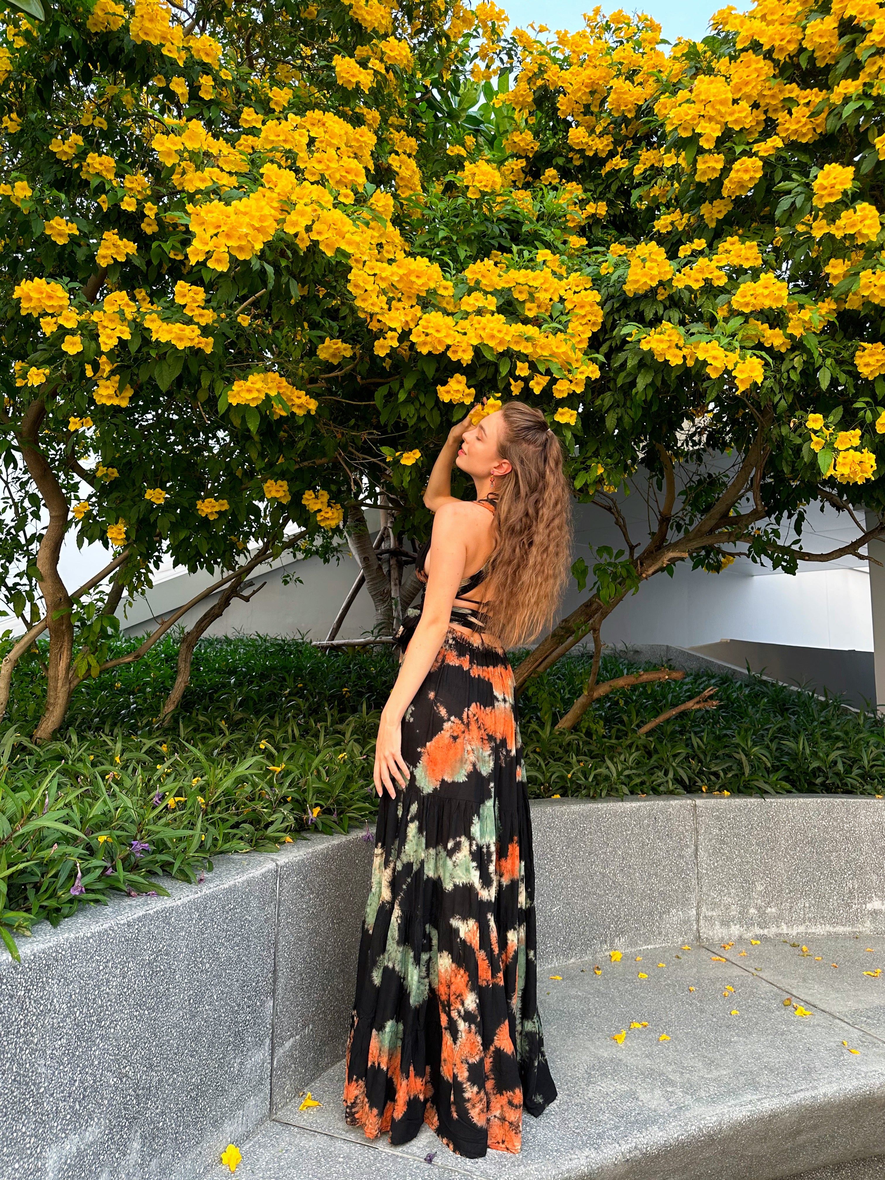 The Butterfly Infinity Maxi Dress Tie Dye is a limited edition piece featuring a maxi-length skirt and captivating hand-tie-dye pattern inspired by butterflies and vacation vibes. The dress is shown in a stylish and versatile design, suitable for transitioning seamlessly from day to night. With the Infinity Dress, you can explore different looks for any occasion. This lightweight and comfortable dress flatters all body types, making it perfect for bohemian style or resort wear.