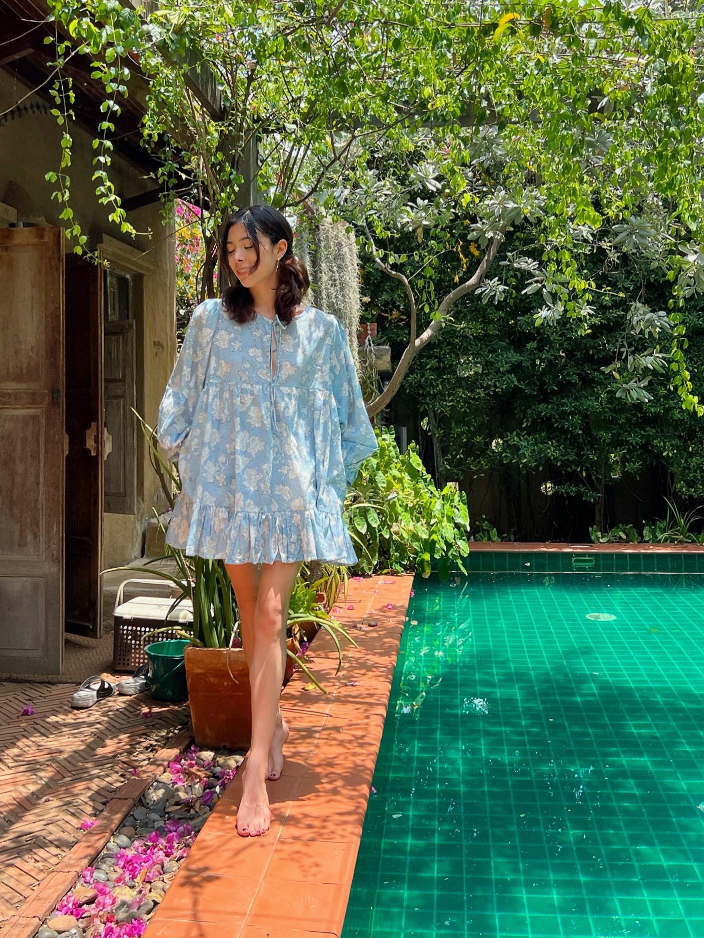 Coco de Chom Lola Bohemian Mini Dress in Beautiful Blue Sky - A Truly Unique Limited Edition Piece. Handcrafted with Wooden Blocks on Fine Cotton Voile, Showcasing a Dreamy Block Printed Pattern Inspired by Bougainvillea Flowers and Vacations. Ideal for Beach Days, Vacations, and Boho Enthusiasts.