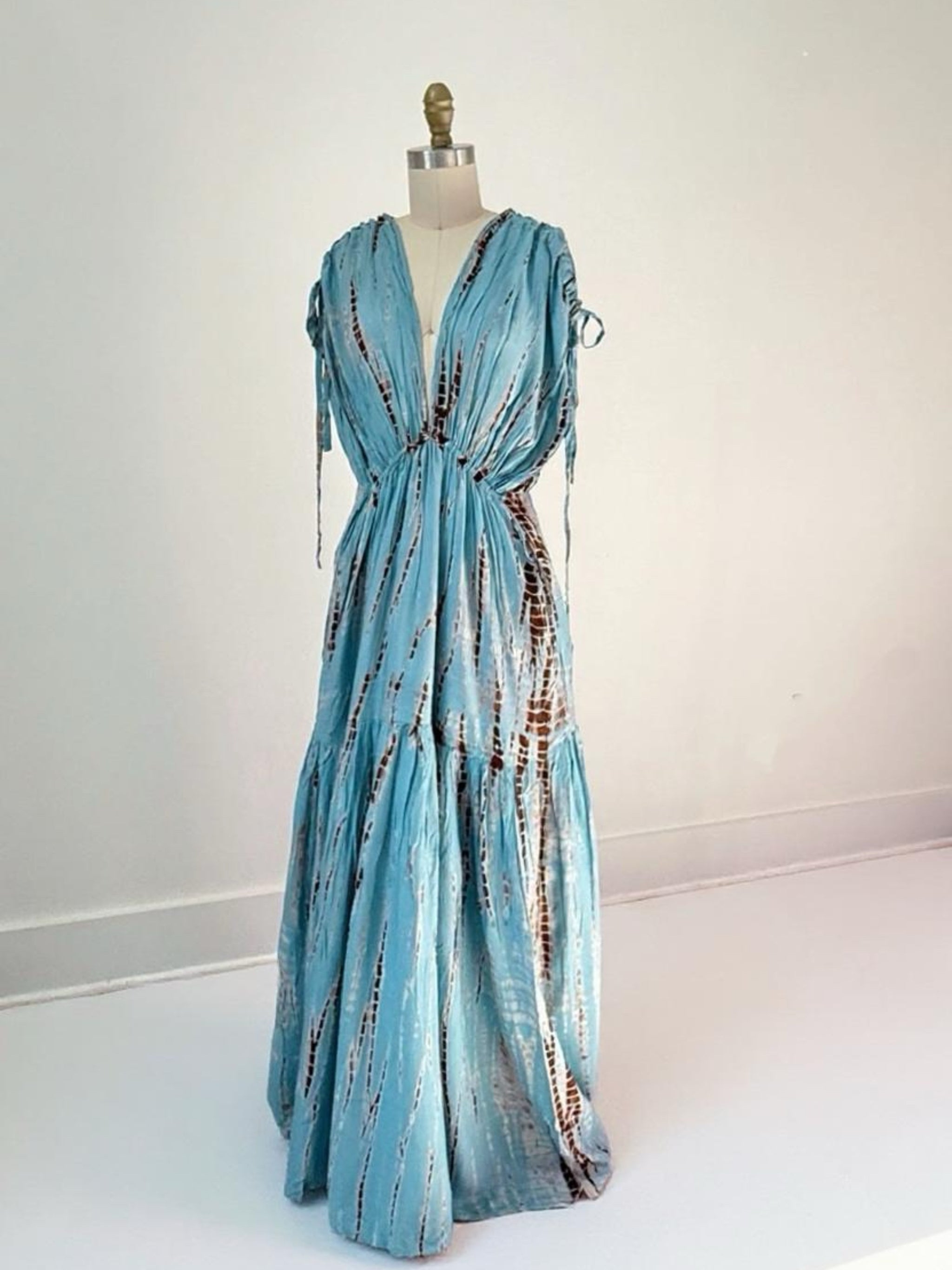 Woman wearing the handmade Athena Goddess Kaftan Dress in teal—flowy tie-dye maxi dress with pockets, deep V-neckline, perfect for summer, resort wear, or festivals.