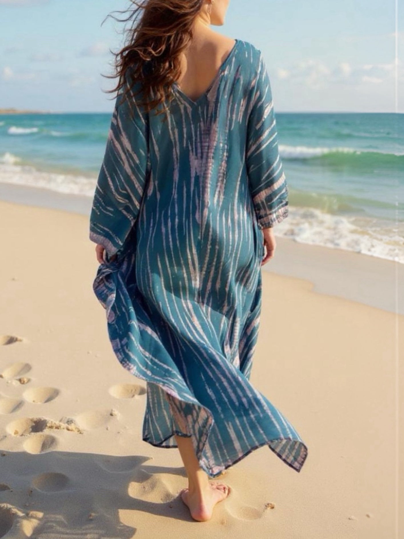 Model wearing a teal tie-dye boho caftan dress; long handmade kaftan perfect as a beach cover-up, vacation kaftan, or oversized resort wear for women. Ideal gift for her and great for lounging or bohemian beachwear style.