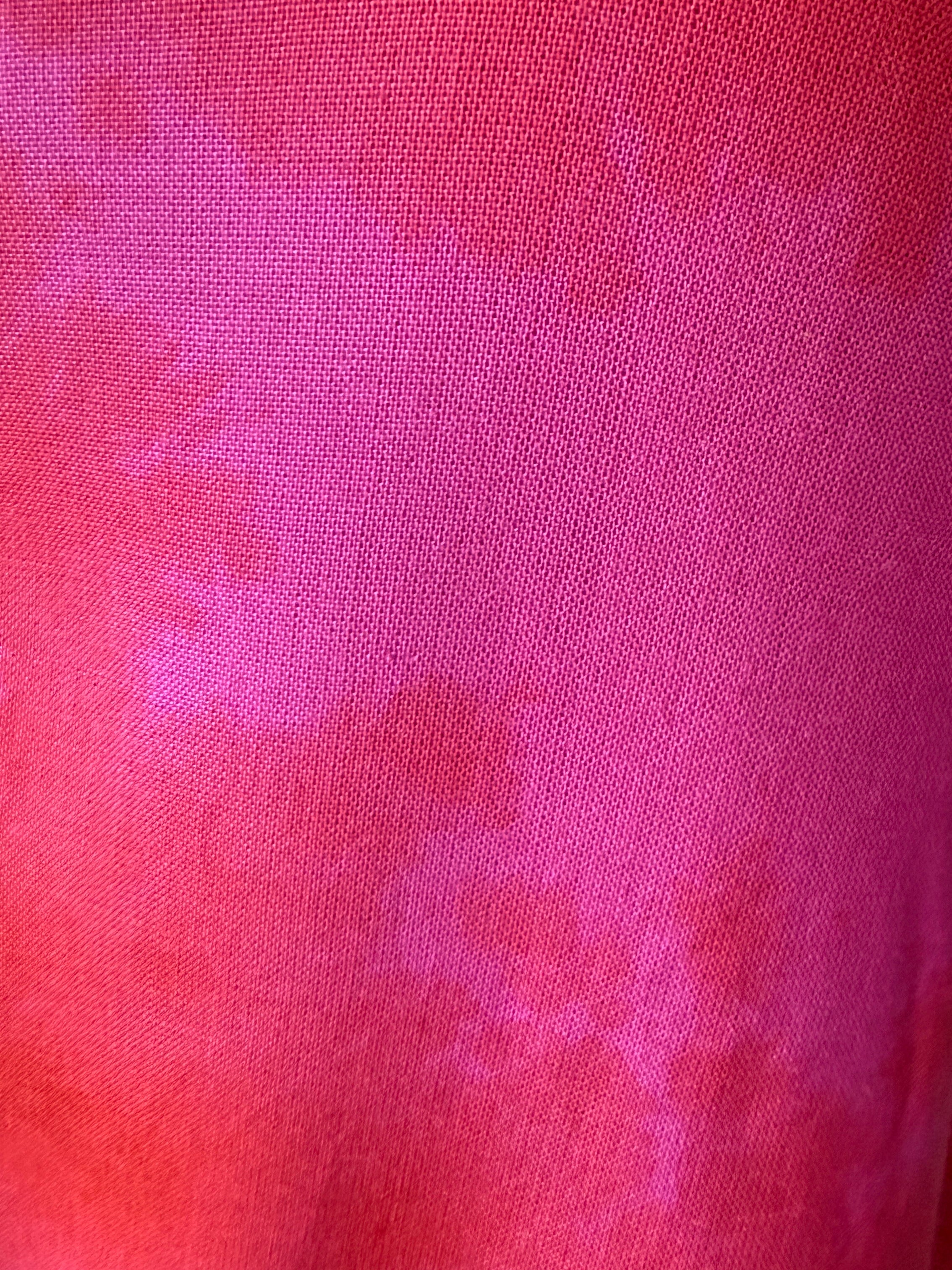 Close-up of pink tie dyed fabric with a subtle pattern