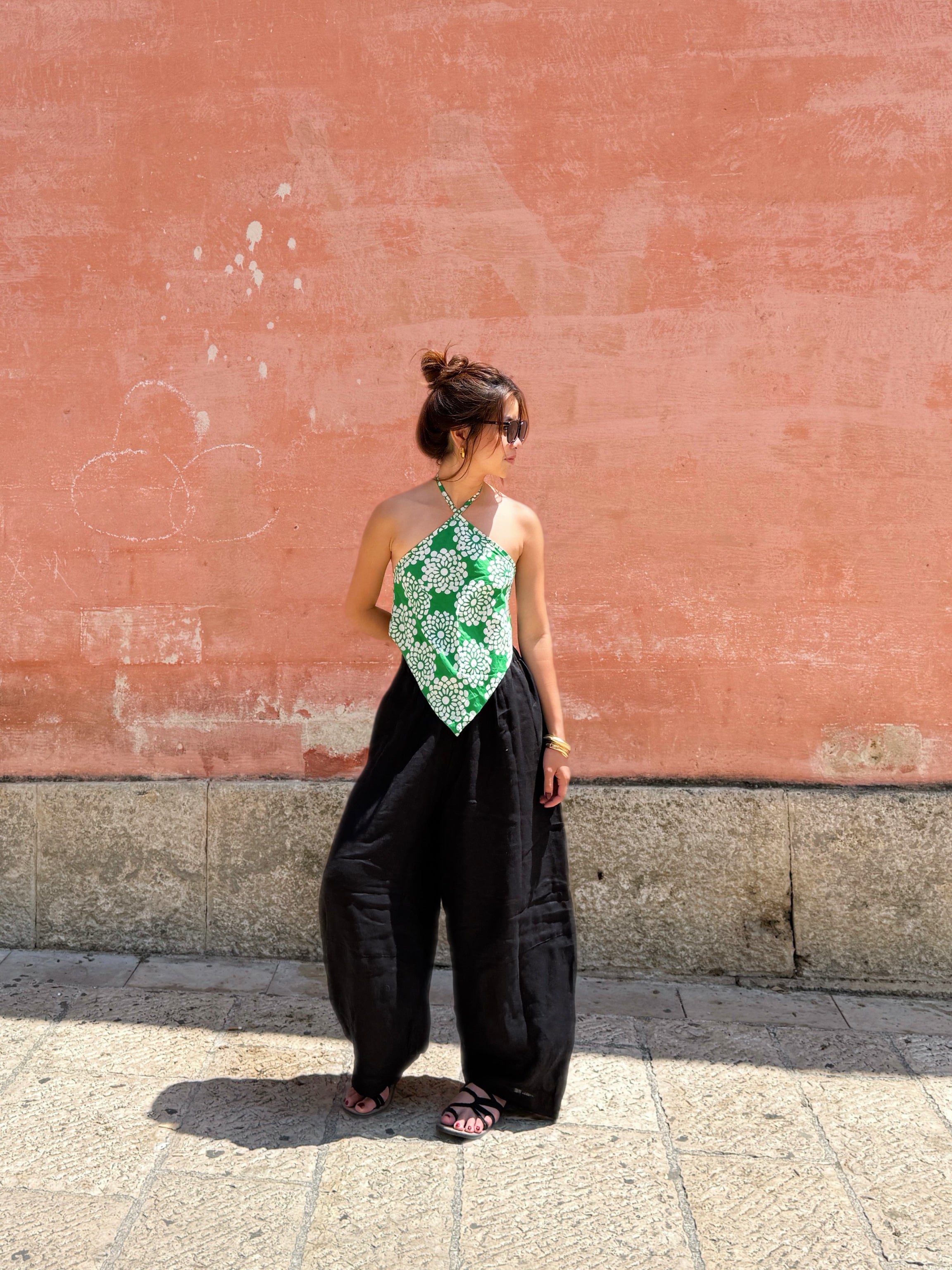 Model wearing flowing black linen wide-leg pants in barrel cut – breathable, handmade boho trousers for women, perfect for summer and travel