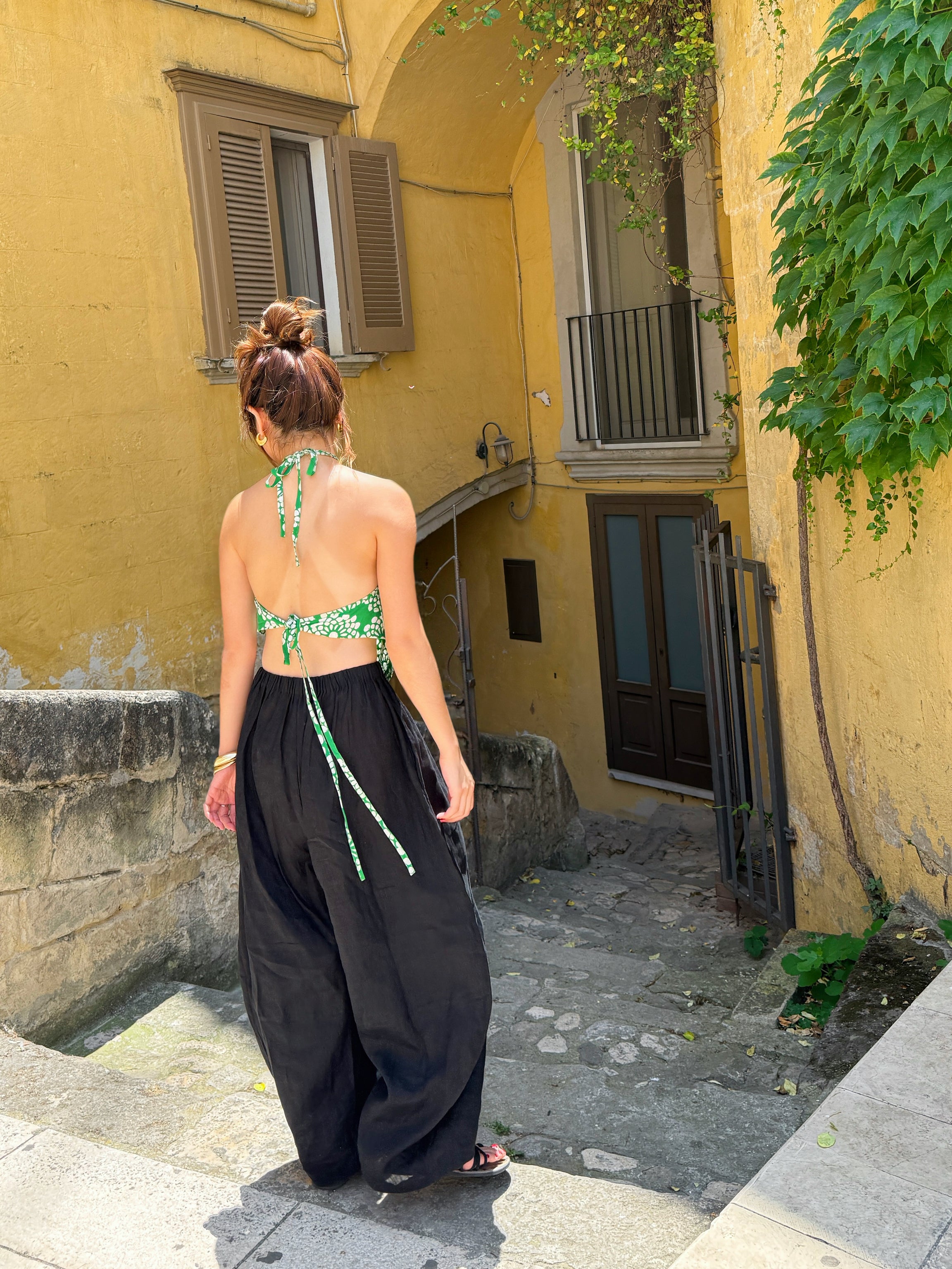 Model wearing flowing black linen wide-leg pants in barrel cut – breathable, handmade boho trousers for women, perfect for summer and travel