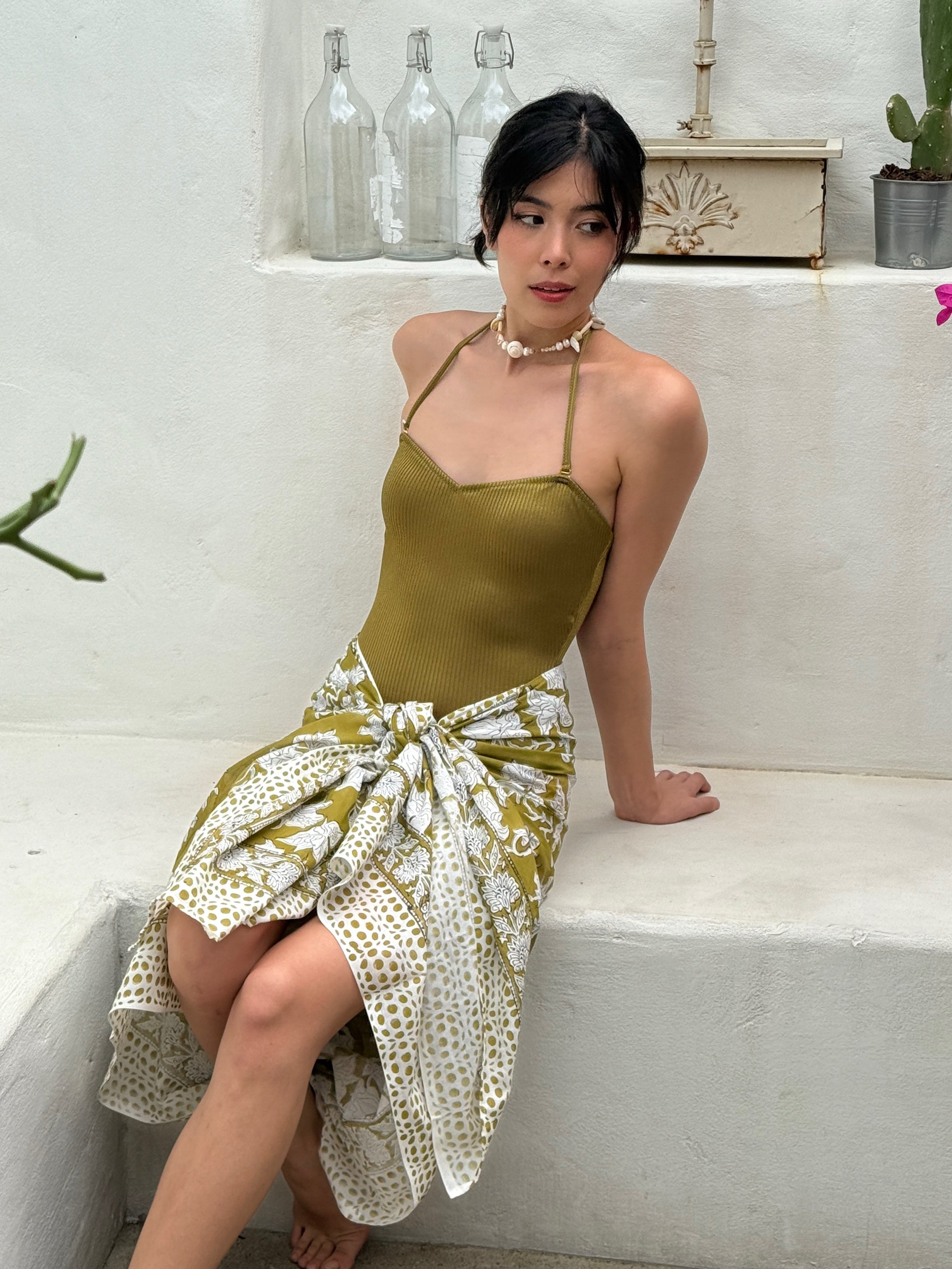 Model wearing floral hand-blocked cotton sarong as a beach wrap skirt – lightweight boho resortwear for vacation