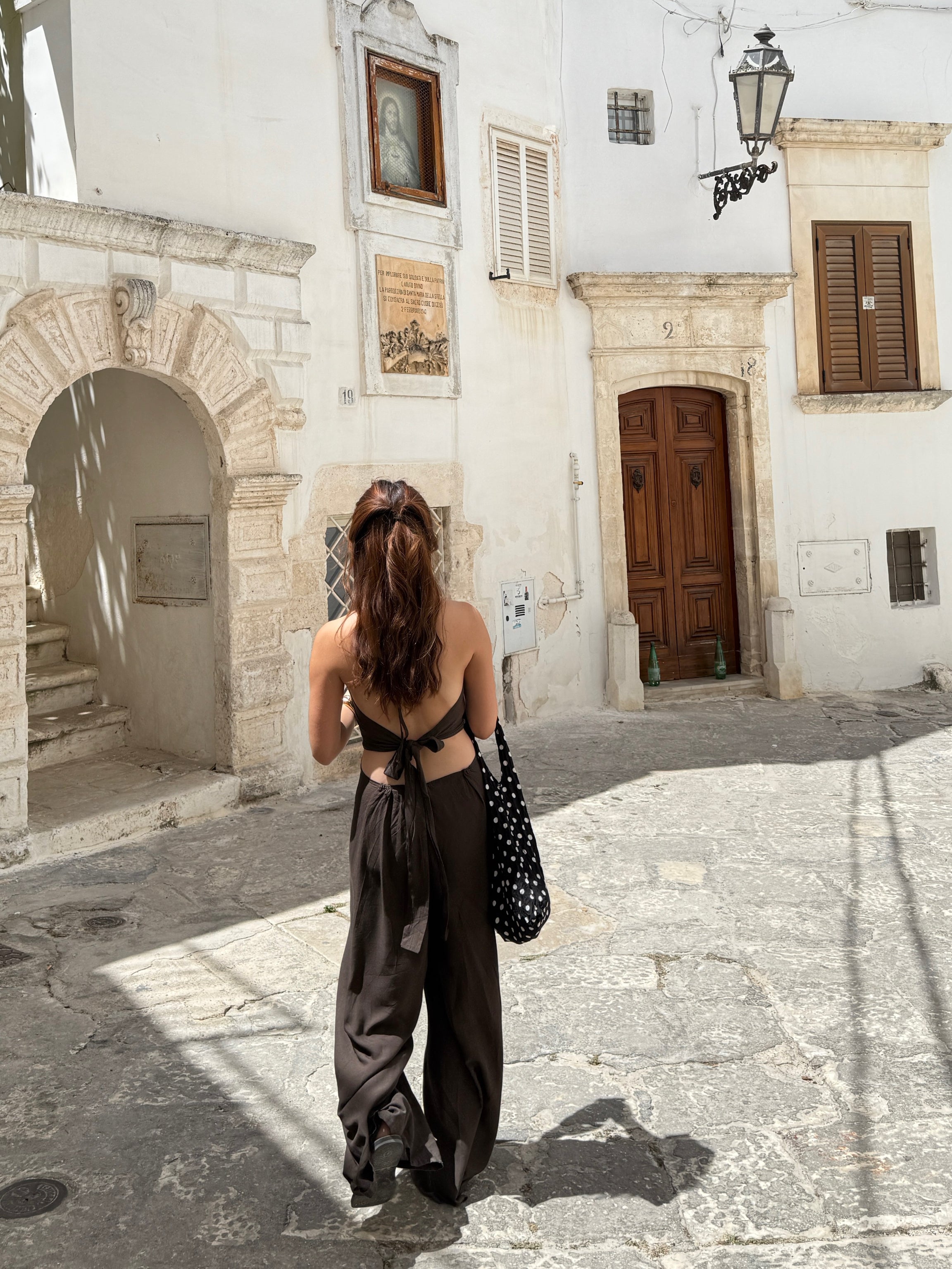 Back view showing adjustable tie straps and open-back design—versatile vacation outfit.