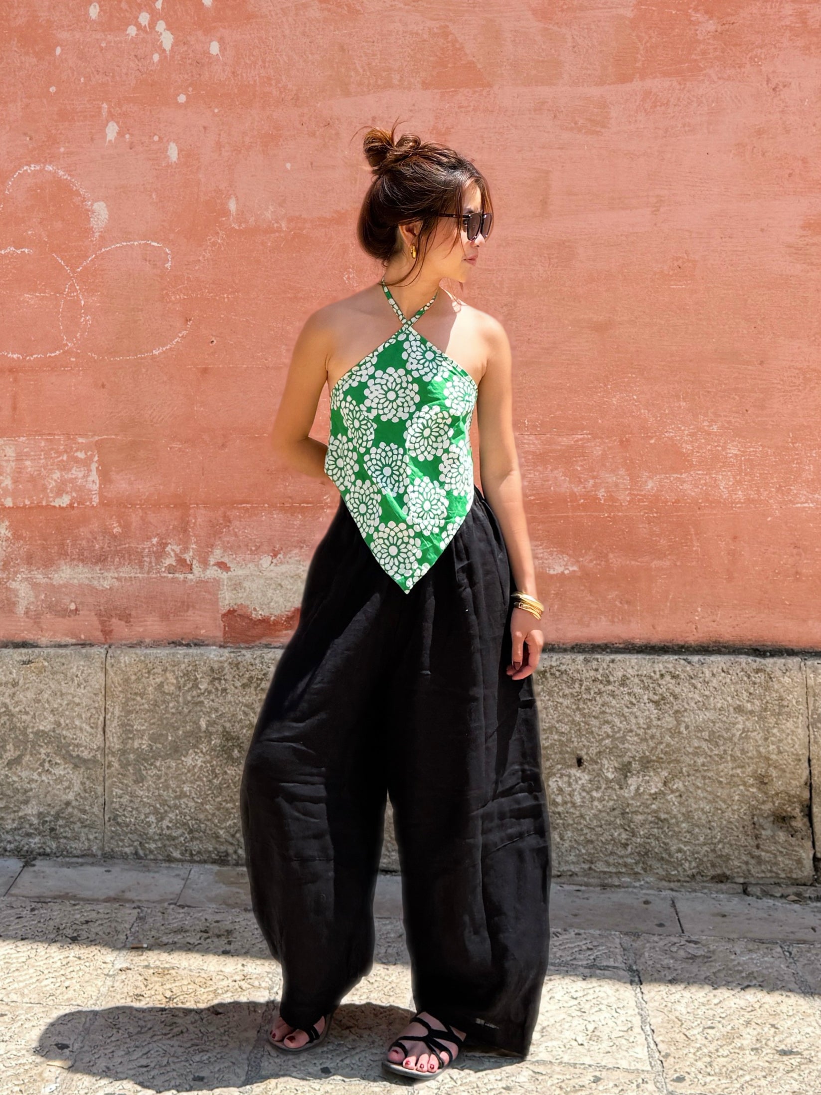 Model wearing green tropical flower batik halter crop top – handmade boho beachwear.