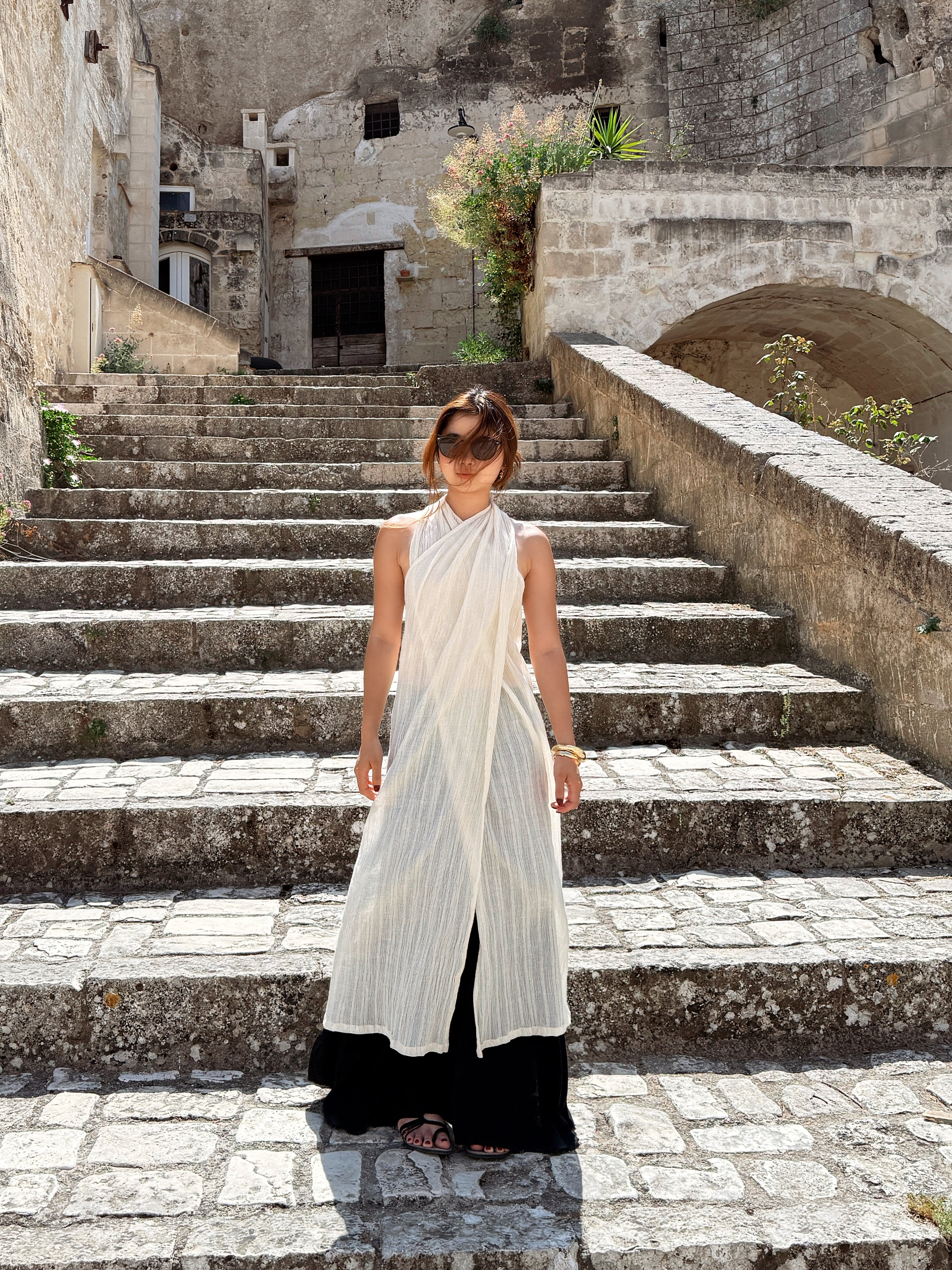 Convertible beach cotton cover-up styled as wrap dress in natural sunlight
