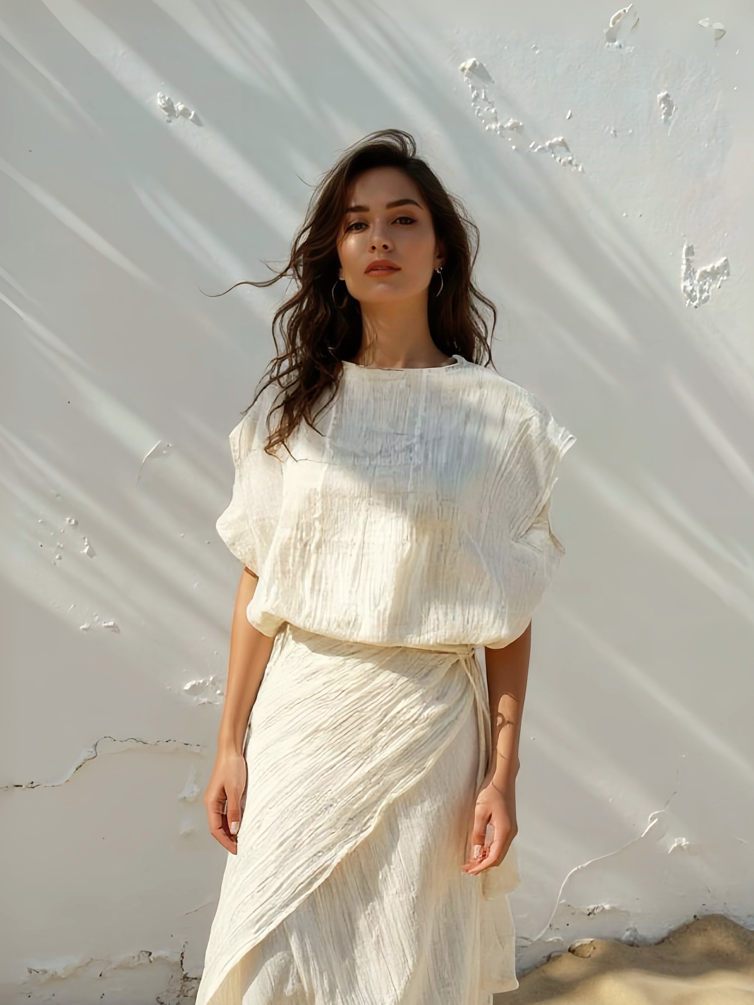 Model wearing off-white crinkle cotton kaftan top with flowing sleeves, handmade