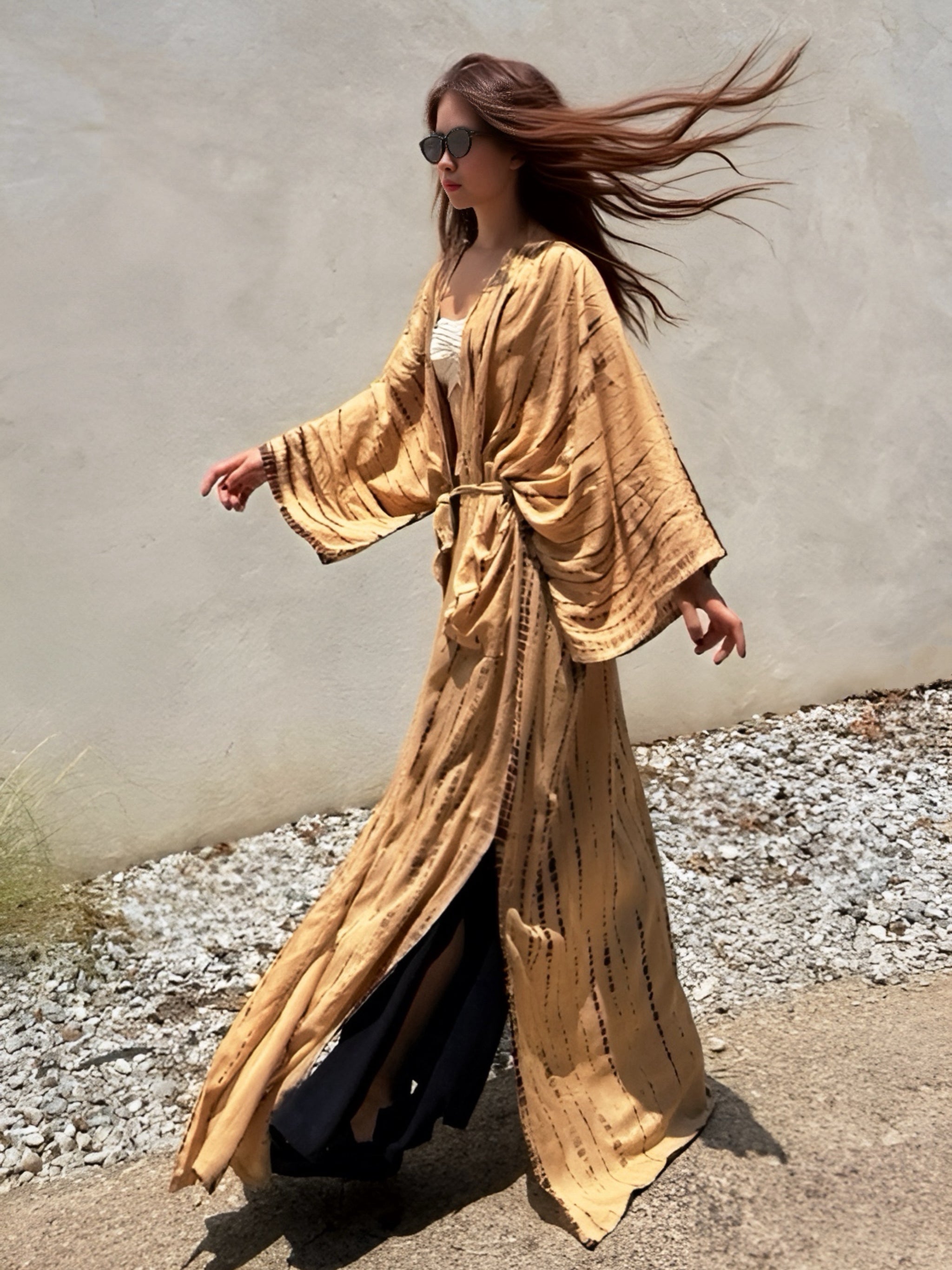 Woman wearing a tan tie-dye long kimono robe from Coco de Chom. The oversized robe features long sleeves, a waist tie, and a relaxed, boho-style fit.