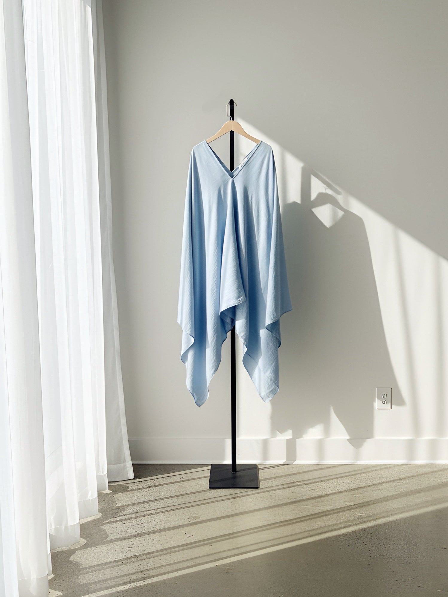 A blue kaftan style tunic top or blue mini kaftan dress hanging perfect beach cover up or resortwear