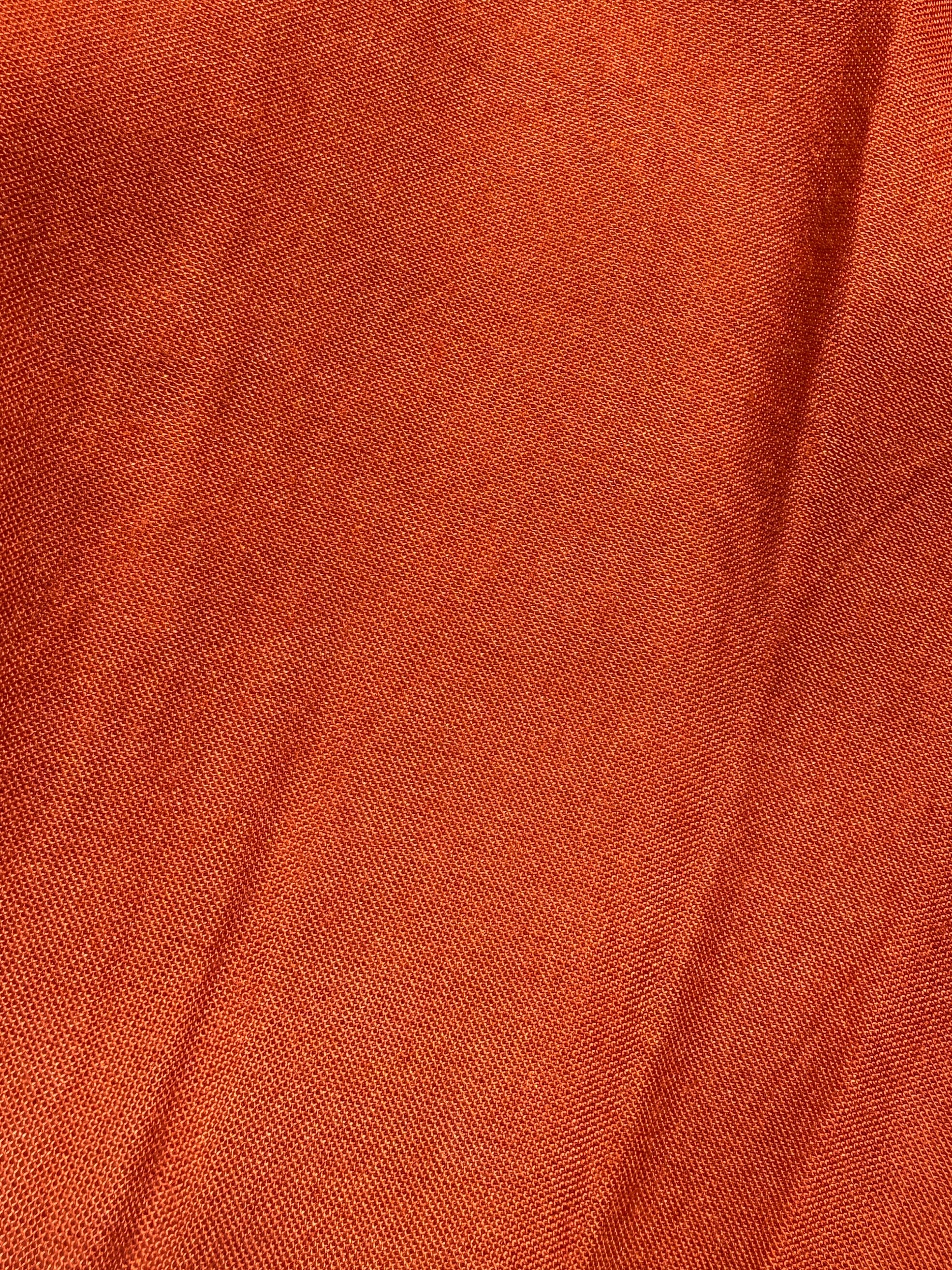 Close-up of orange fabric with a textured pattern