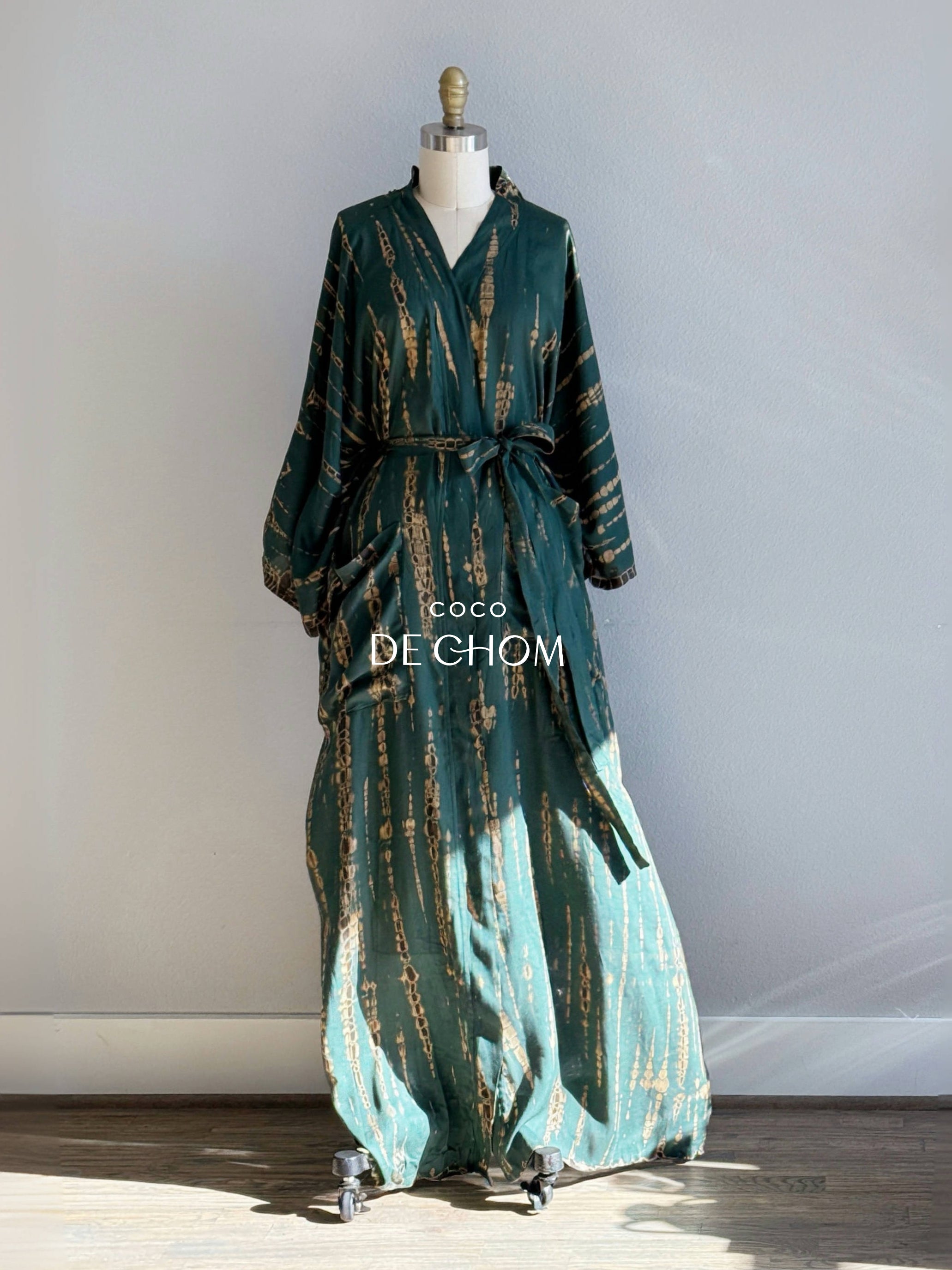 tie-dye kimono dress displayed on a mannequin, featuring long sleeves, a V-neckline, and a loose, flowy fit. This handmade boho kimono maxi dress is comfy and lightweight — perfect for beach days, lounging, and boho lovers. A beautiful gift for her, ideal for resort wear, vacation outfits, and sustainable fashion shoppers.