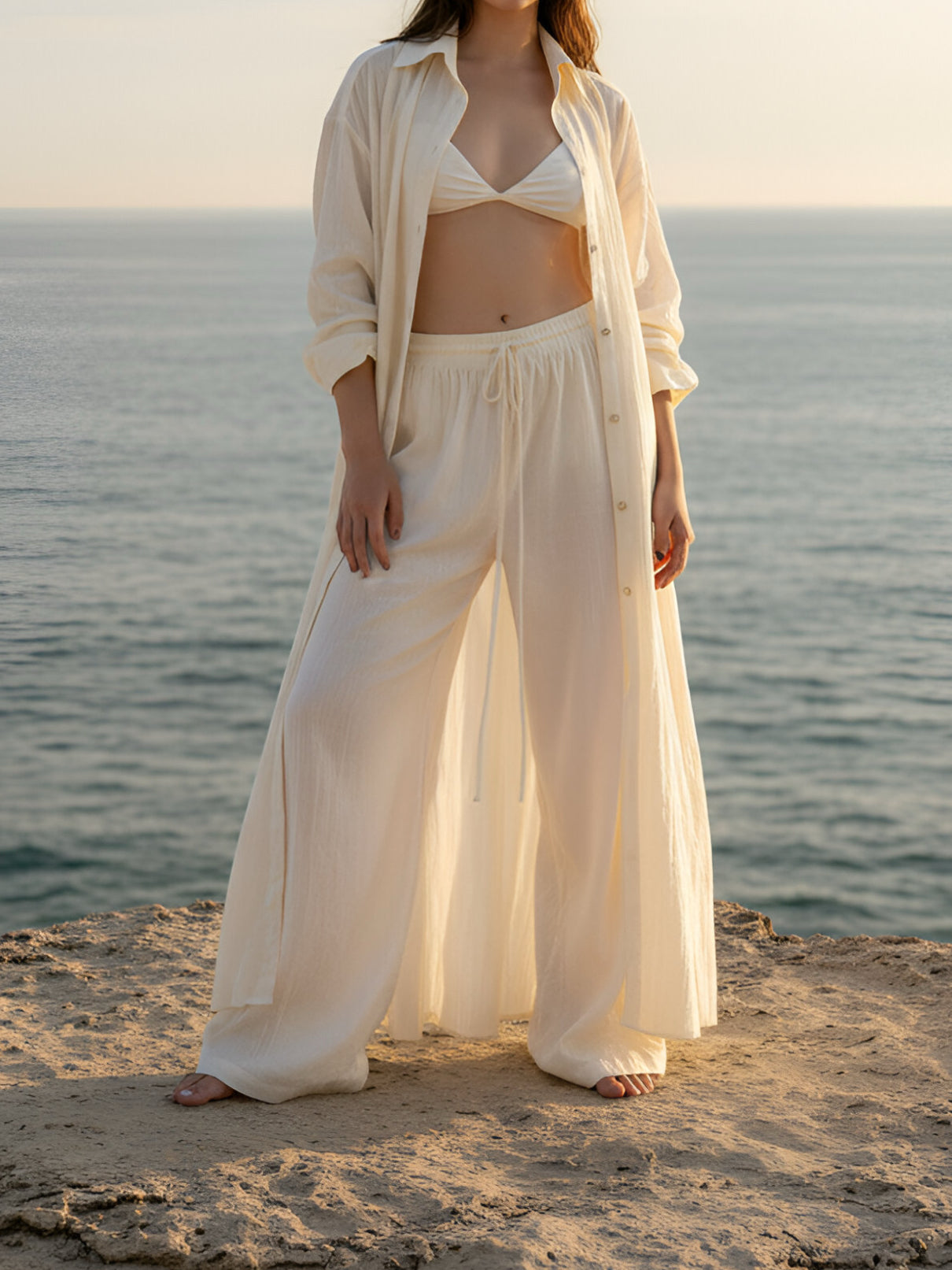 Model wearing organic cotton wide-leg pants with elastic waist, lightweight boho beach pants for summer and resort wear