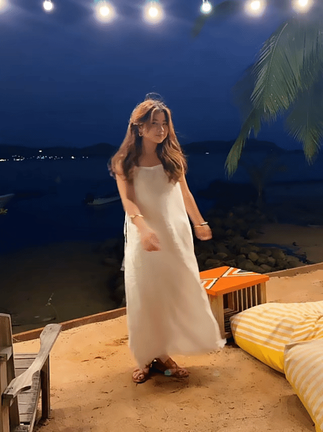 Model dancing in white linen slip dress on the beach – minimalist summer look with natural linen fabric- perfect white dress for summer – eco-friendly summer wardrobe essential