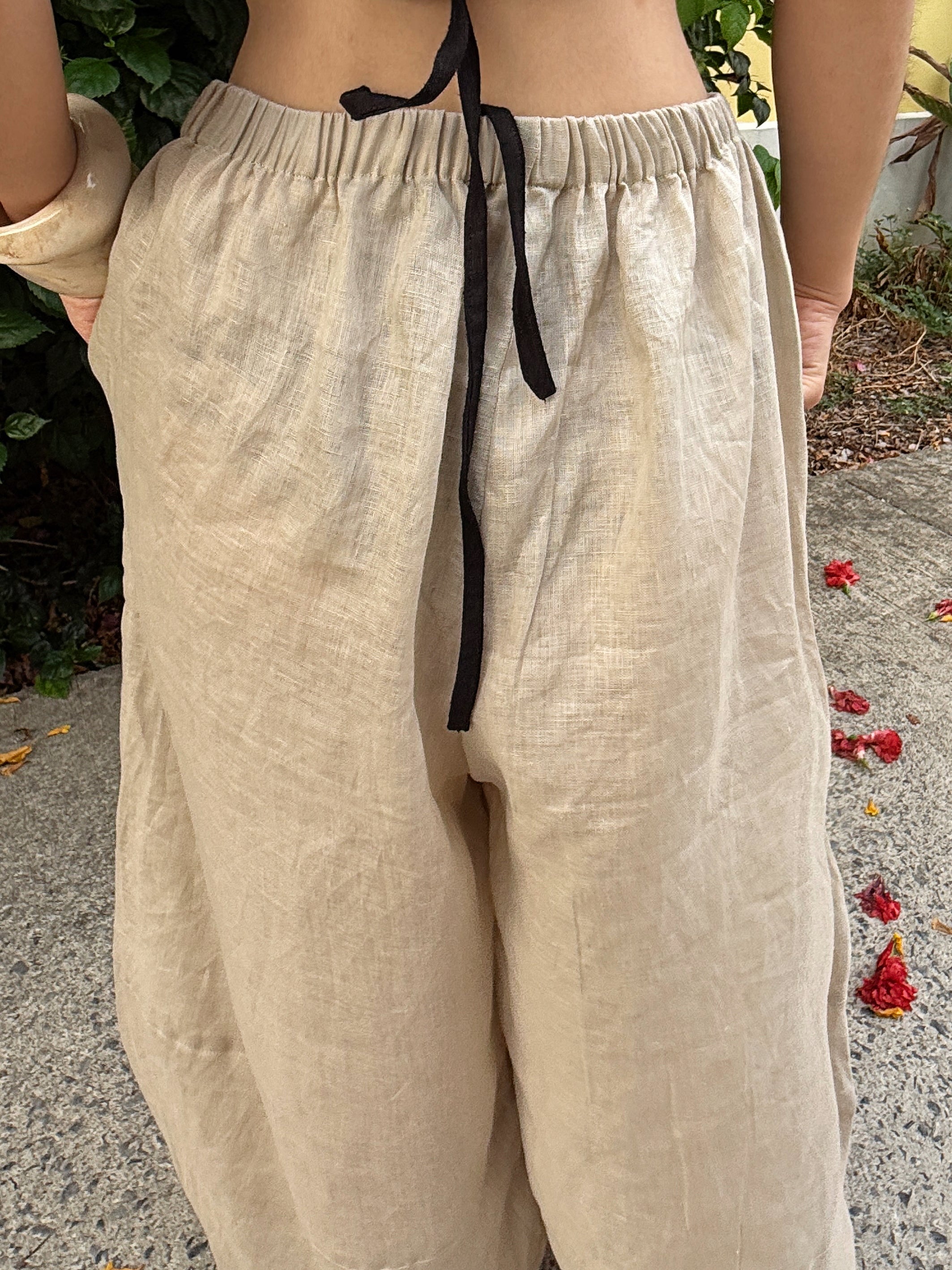 Close up barrel cut linen boho pants on beach vacation – lightweight wide-leg trousers styled for effortless travel and summer comfort