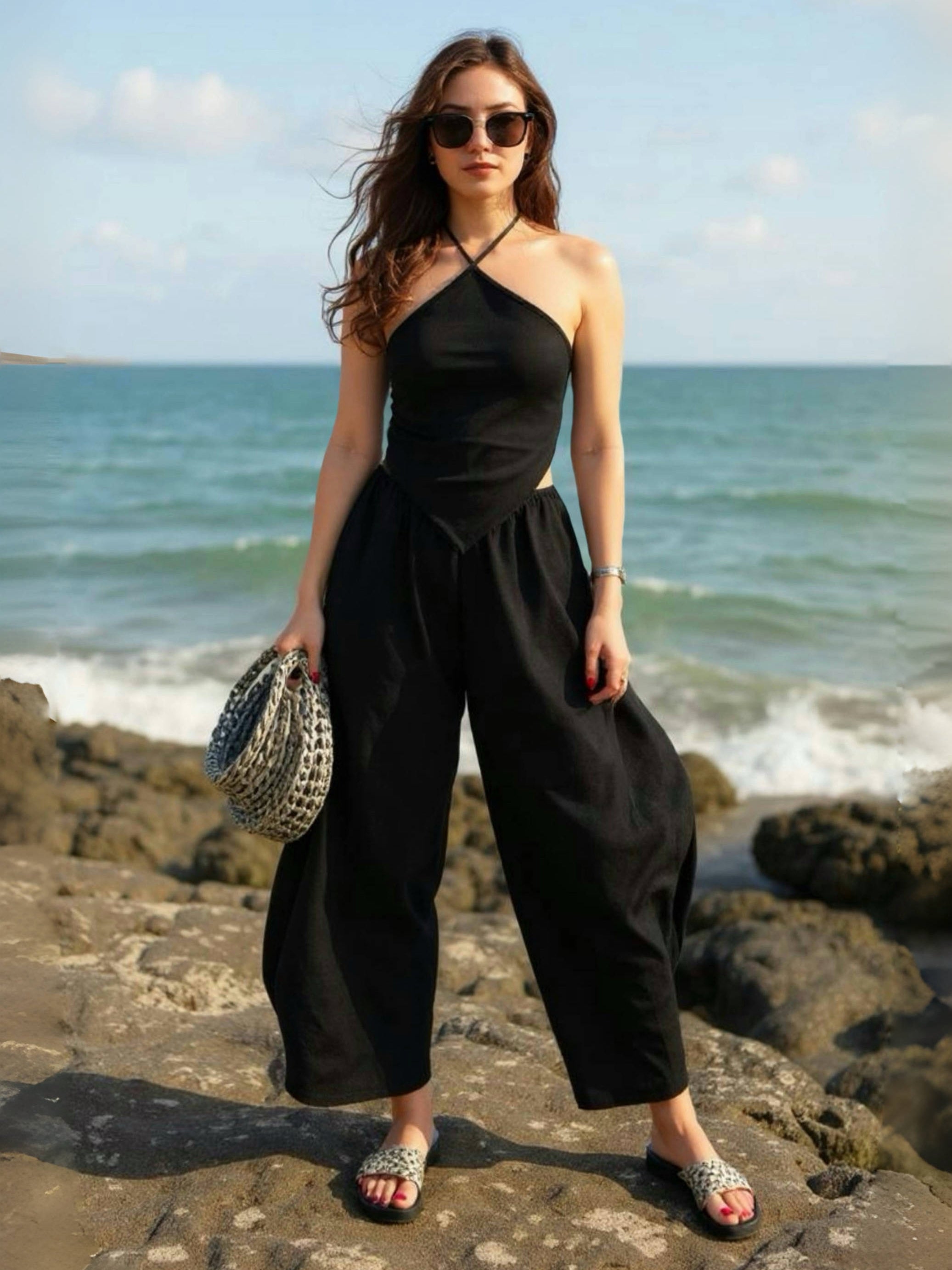 Model wearing flowing black linen wide-leg pants in barrel cut – breathable, handmade boho trousers for women, perfect for summer and travel