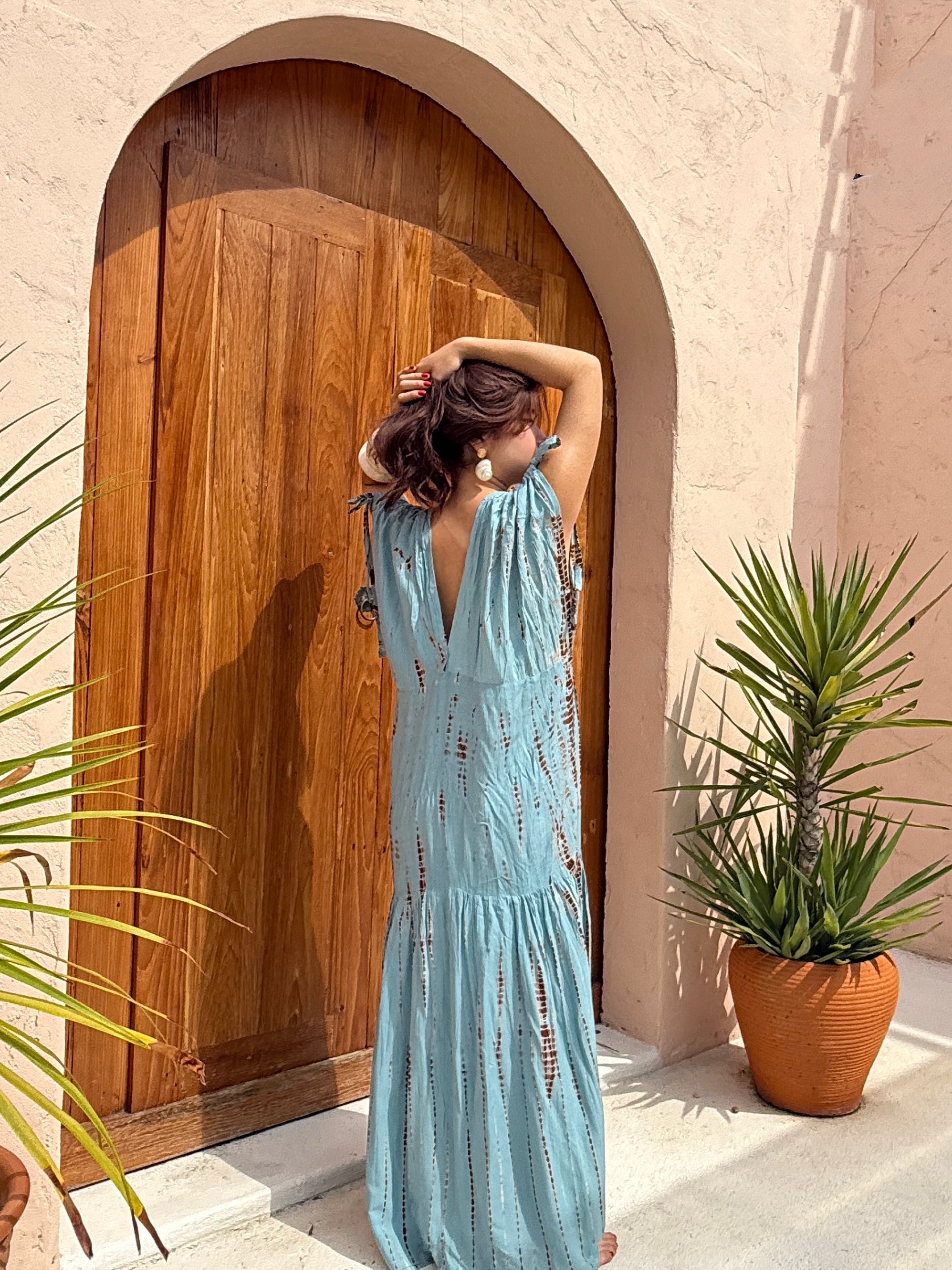 Woman wearing the handmade Athena Goddess Kaftan Dress in teal—flowy tie-dye maxi dress with pockets, deep V-neckline, perfect for summer, resort wear, or festivals.