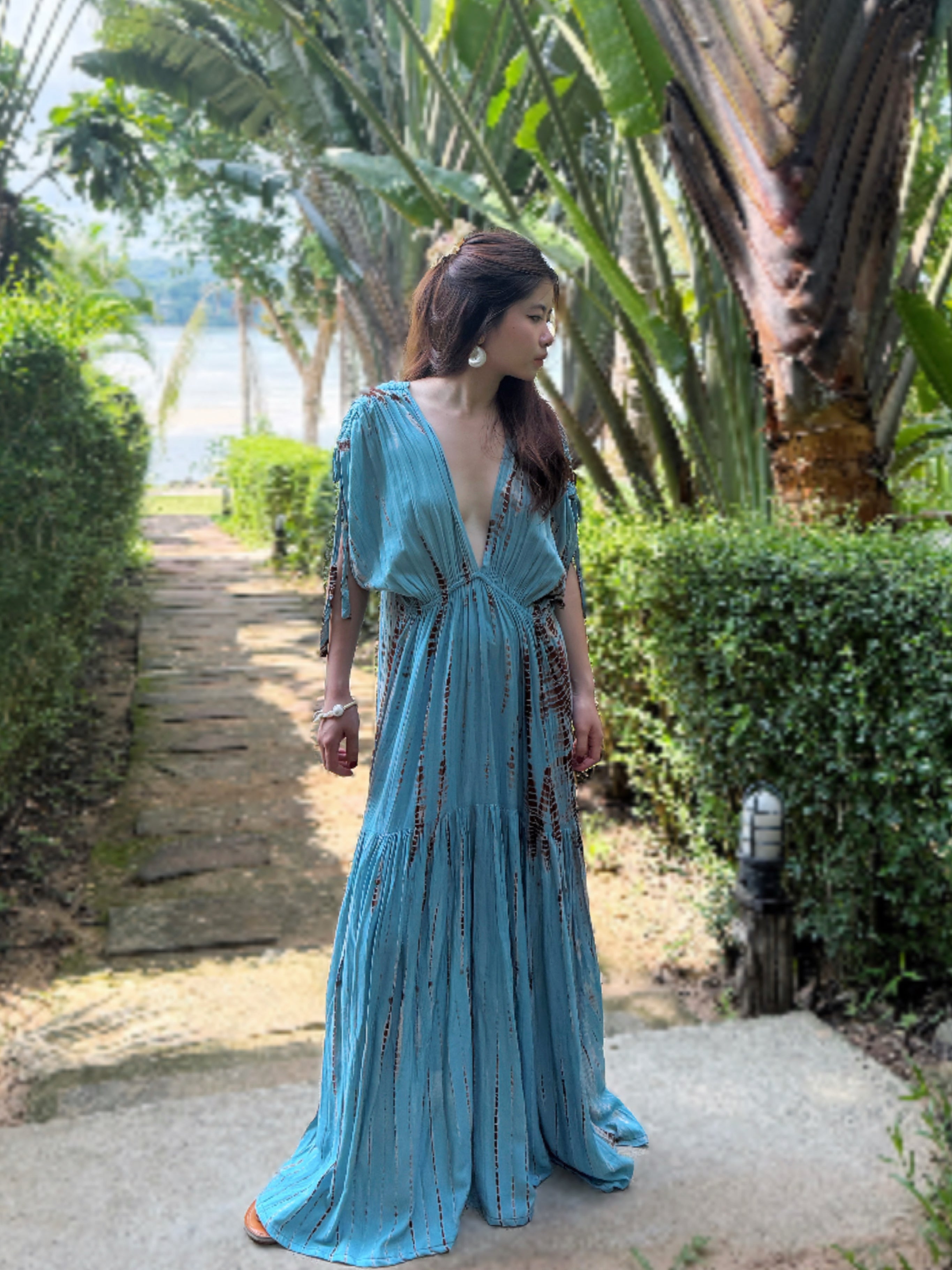 Woman wearing the handmade Athena Goddess Kaftan Dress in teal—flowy tie-dye maxi dress with pockets, deep V-neckline, perfect for summer, resort wear, or festivals.