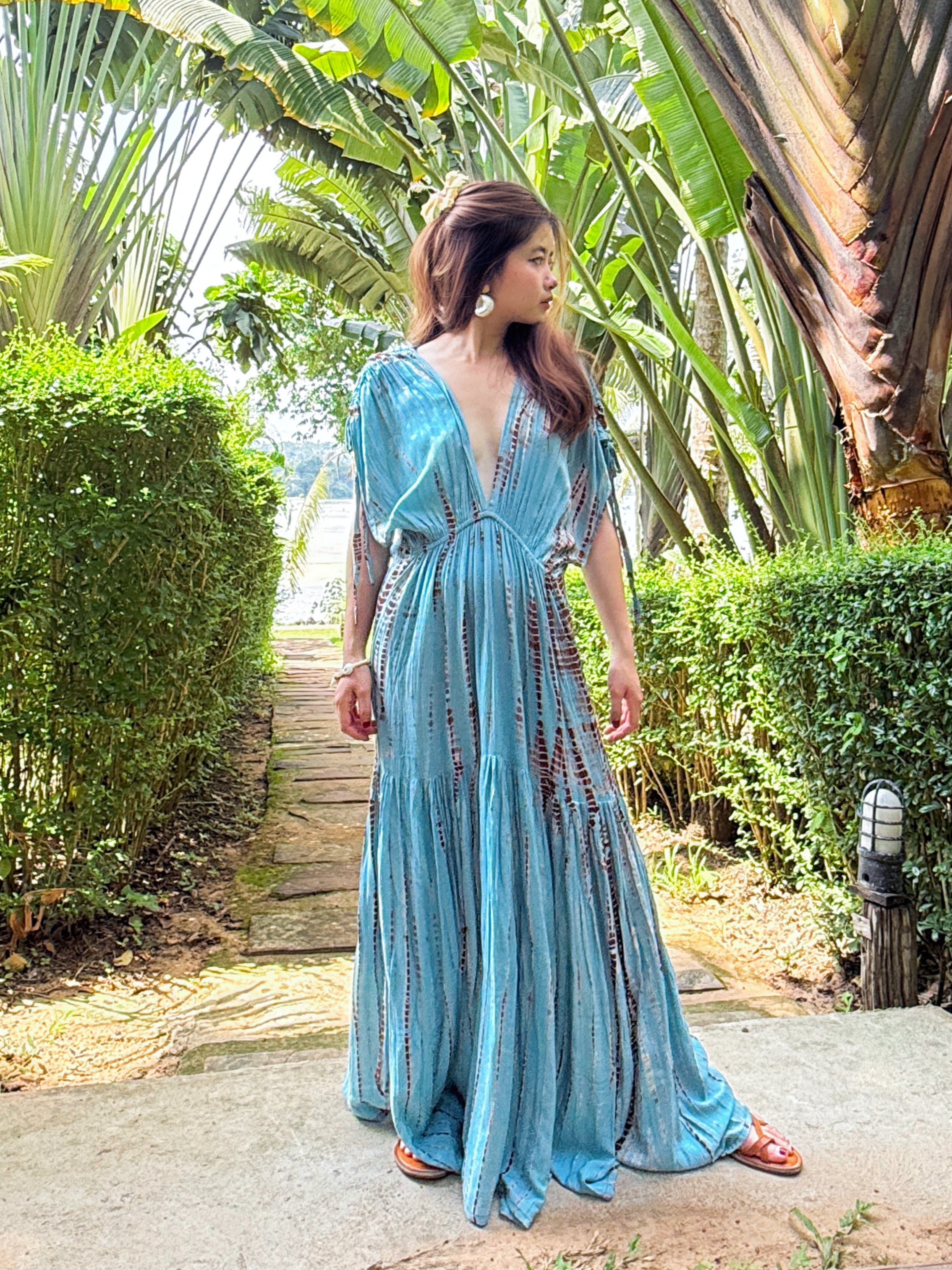 Woman wearing the handmade Athena Goddess Kaftan Dress in teal—flowy tie-dye maxi dress with pockets, deep V-neckline, perfect for summer, resort wear, or festivals.