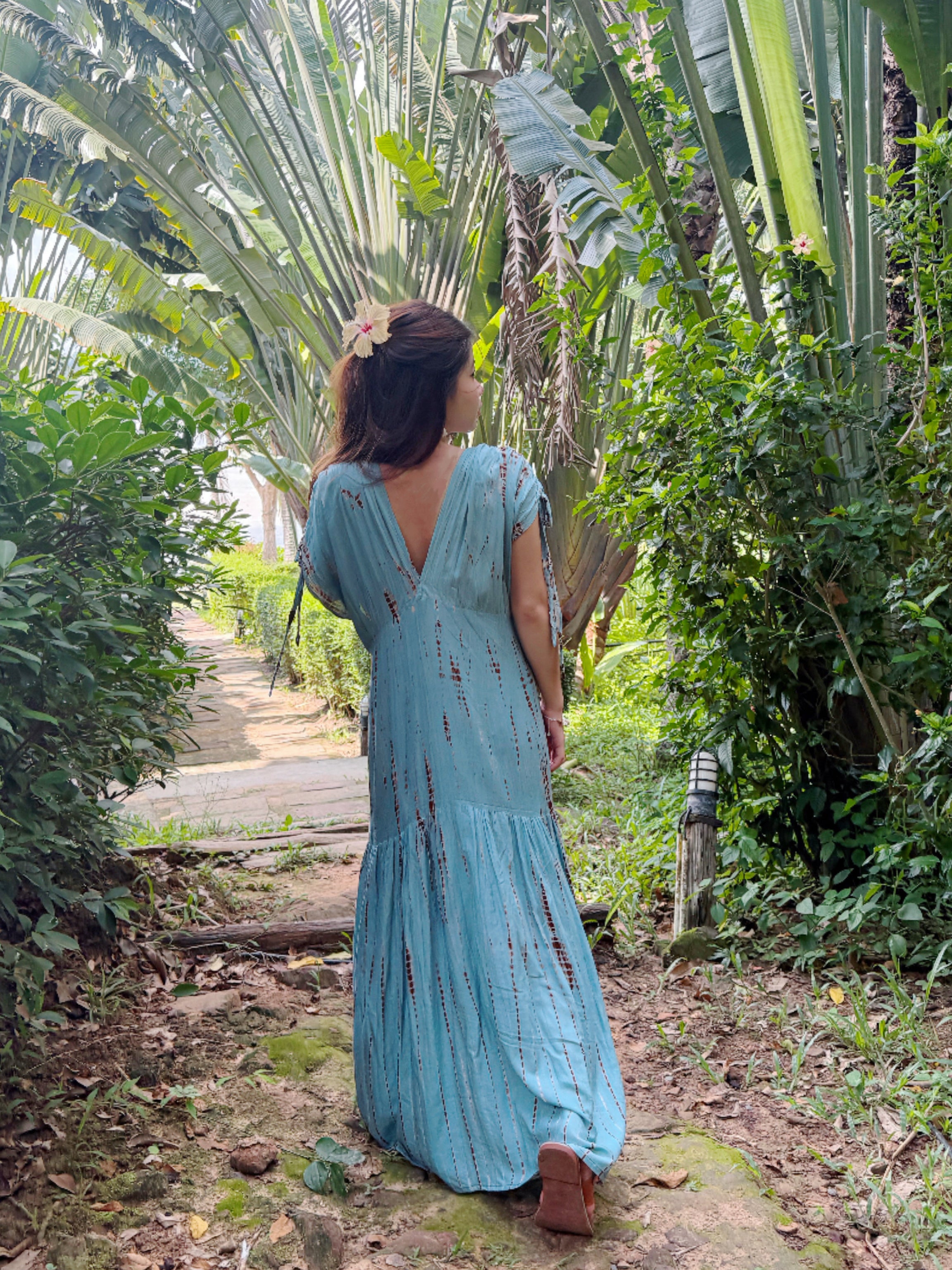 Woman wearing the handmade Athena Goddess Kaftan Dress in teal—flowy tie-dye maxi dress with pockets, deep V-neckline, perfect for summer, resort wear, or festivals.