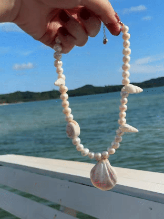 Model wearing the handmade Statement Seashell Pearl Choker, featuring natural freshwater pearls, real seashells, and tribal silver closure—styled as coastal boho jewelry, perfect for beach weddings, honeymoons, and resort wear.