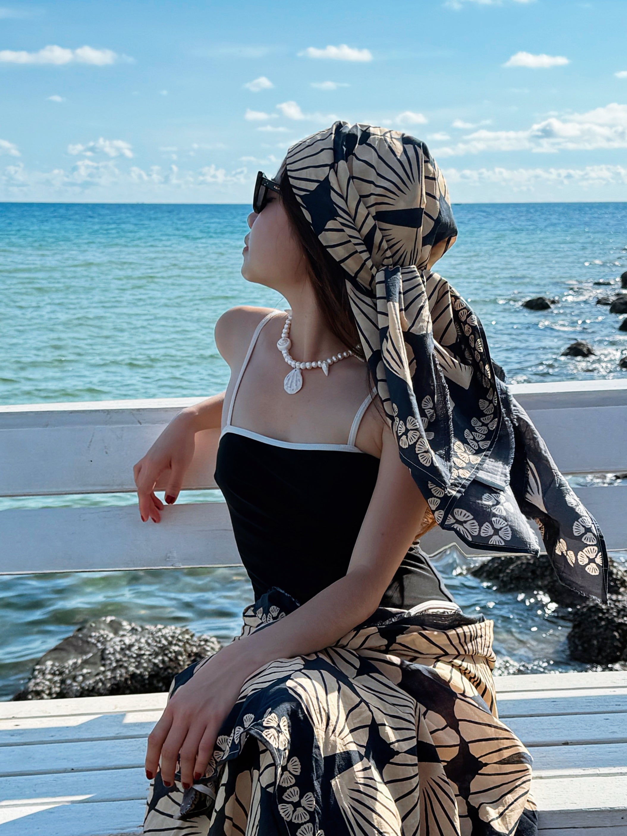 Model wearing the handmade Statement Seashell Pearl Choker, featuring natural freshwater pearls, real seashells, and tribal silver closure—styled as coastal boho jewelry, perfect for beach weddings, honeymoons, and resort wear.
