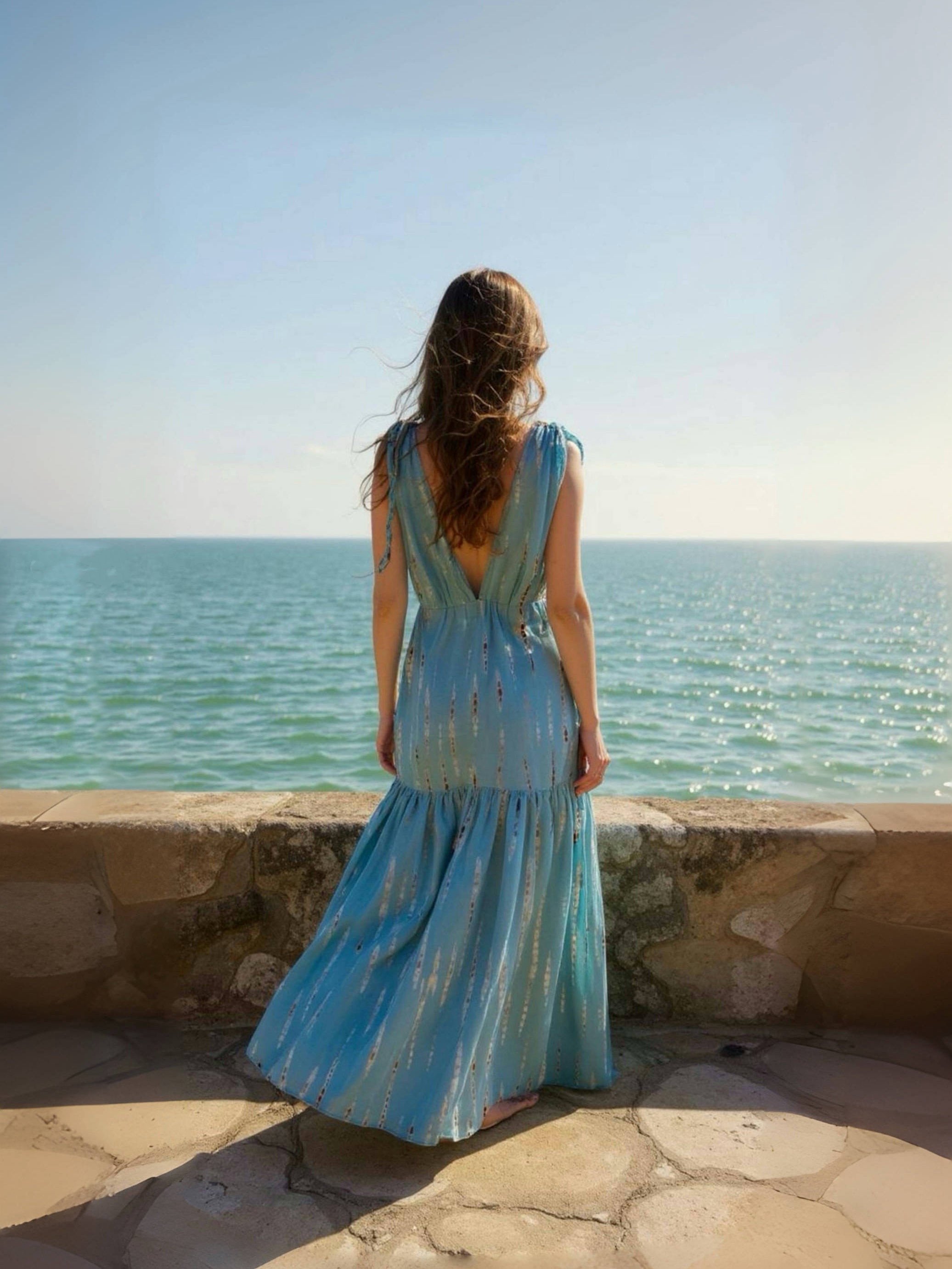 Woman wearing the handmade Athena Goddess Kaftan Dress in teal—flowy tie-dye maxi dress with pockets, deep V-neckline, perfect for summer, resort wear, or festivals.