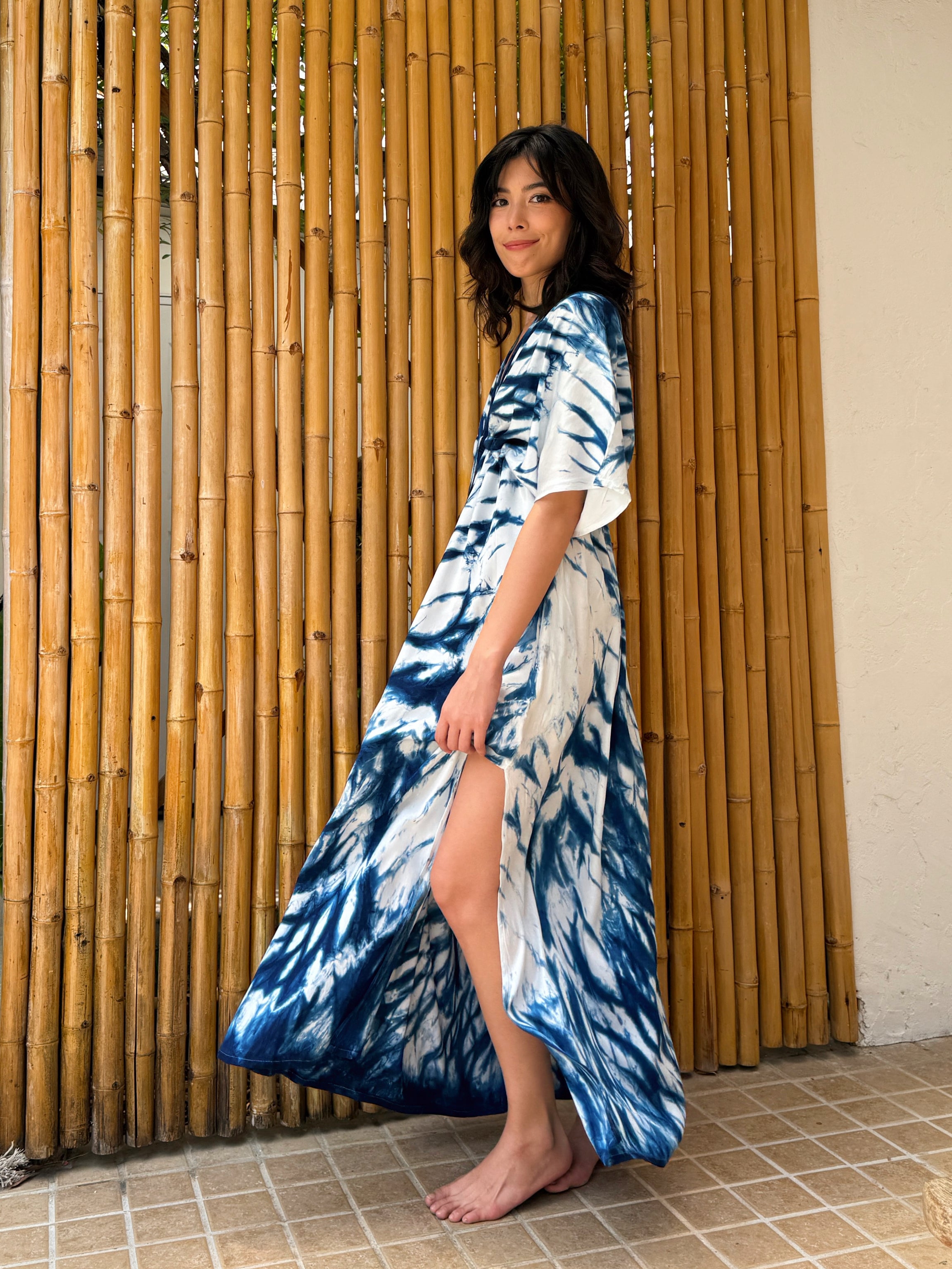 Model wearing the Limited Edition Kori Natural Indigo Goddess Maxi Dress, handcrafted with traditional tie-dye techniques using natural indigo—features a deep V-neckline, flowy silhouette, and adjustable waist, showcasing artisan-made, eco-friendly fashion.