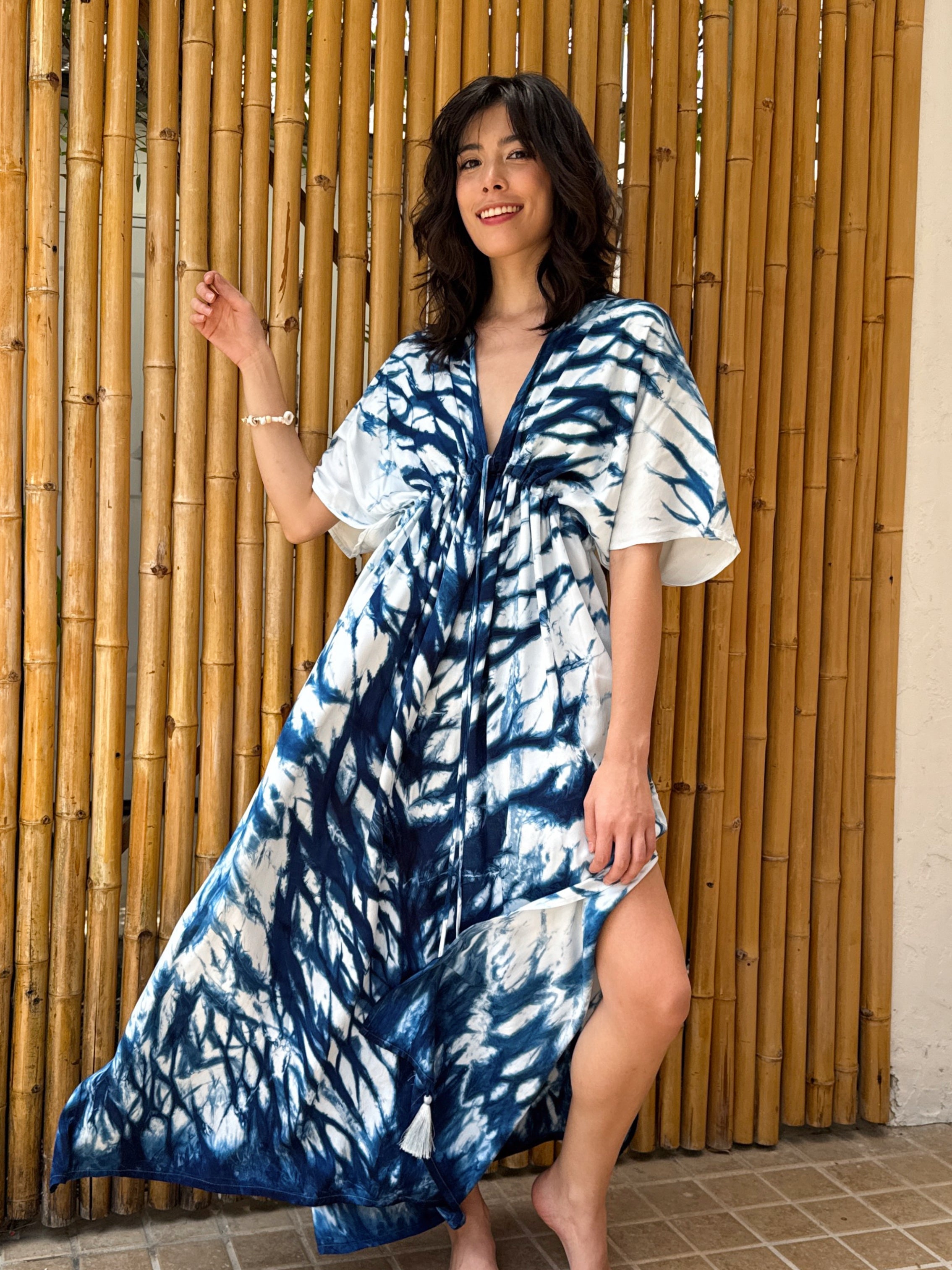 Model wearing the Limited Edition Kori Natural Indigo Goddess Maxi Dress, handcrafted with traditional tie-dye techniques using natural indigo—features a deep V-neckline, flowy silhouette, and adjustable waist, showcasing artisan-made, eco-friendly fashion.