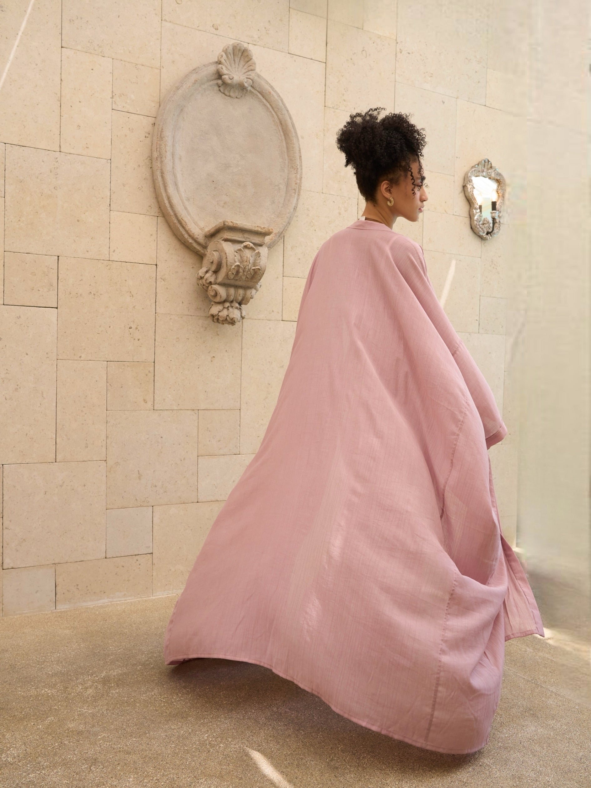 Woman wearing oversized mauve kimono kaftan as lightweight resort cover up, styled for beach and vacation wear by COCO DE CHOM