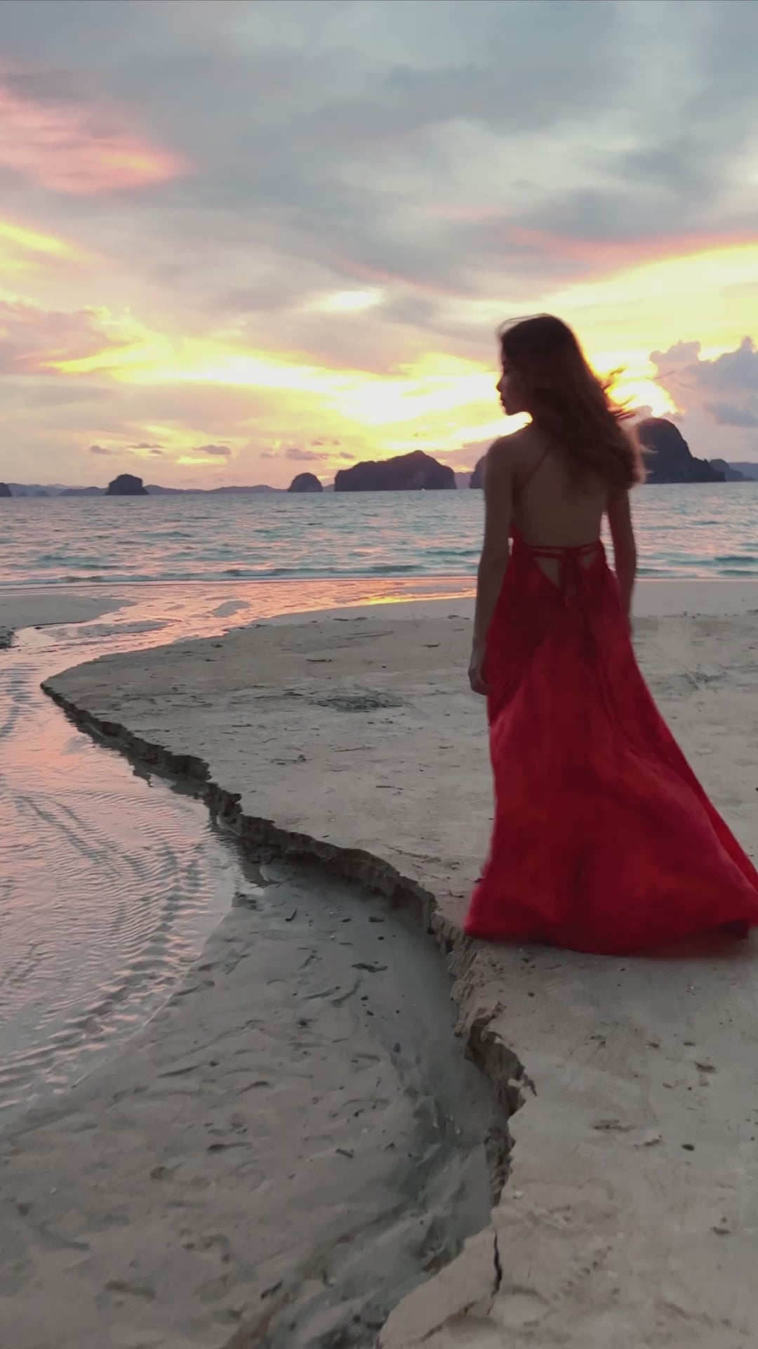 Woman wearing an orange tie-dye open Back Halter Maxi Dress in vibrant orange tie-dye, featuring a flowing maxi length and backless halter design—perfect vacation dress by Coco De Chom.