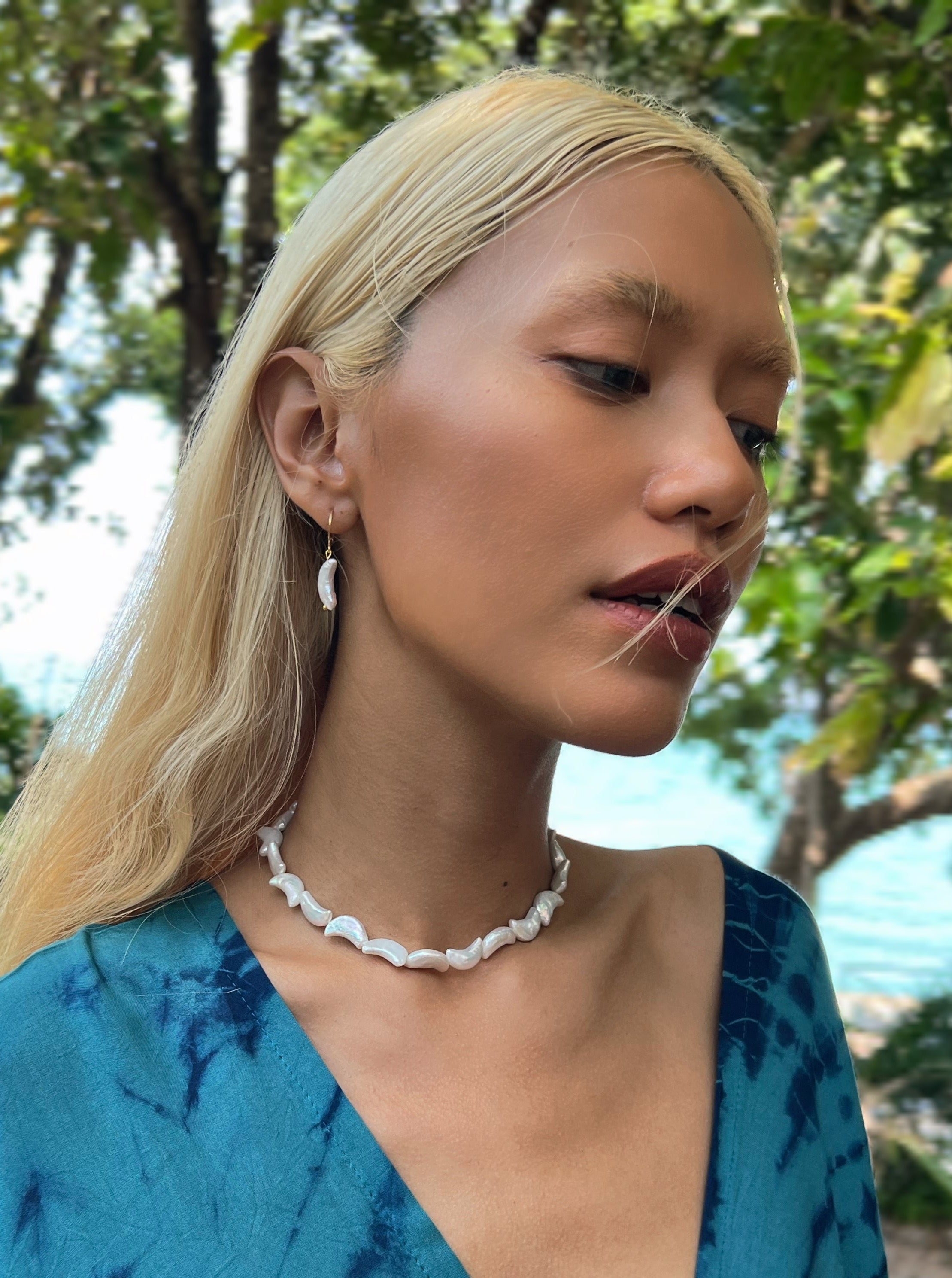 Moon Pearl Choker Necklace is the perfect choice for beach vacation or every day wear. This pearl necklace is made using natural water fresh pearl understated elegance.